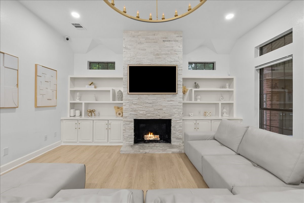 A beautiful gas fireplace creates an inviting focal point, offering the perfect place to unwind while adding warmth and ambiance throughout the space.