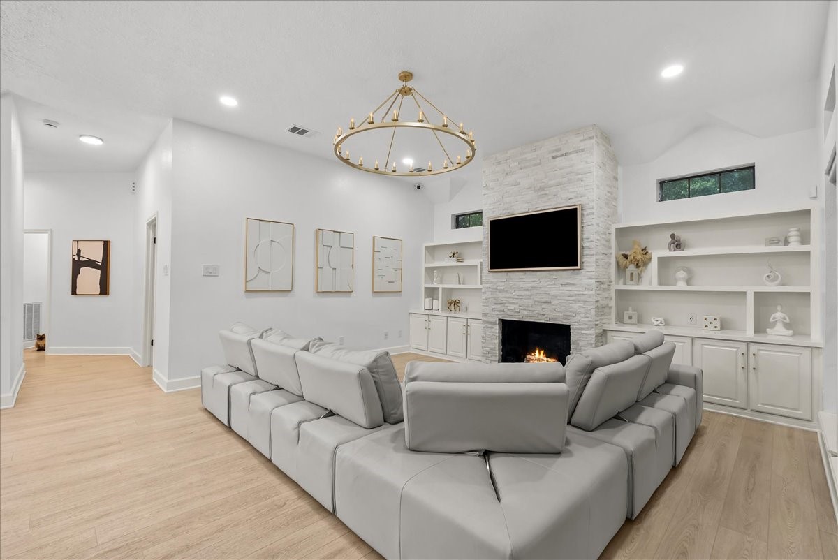 Designed for both quiet evenings and lively gatherings, the family room blends warmth and sophistication with custom built-ins, timeless finishes, and an effortless connection to the heart of the home.