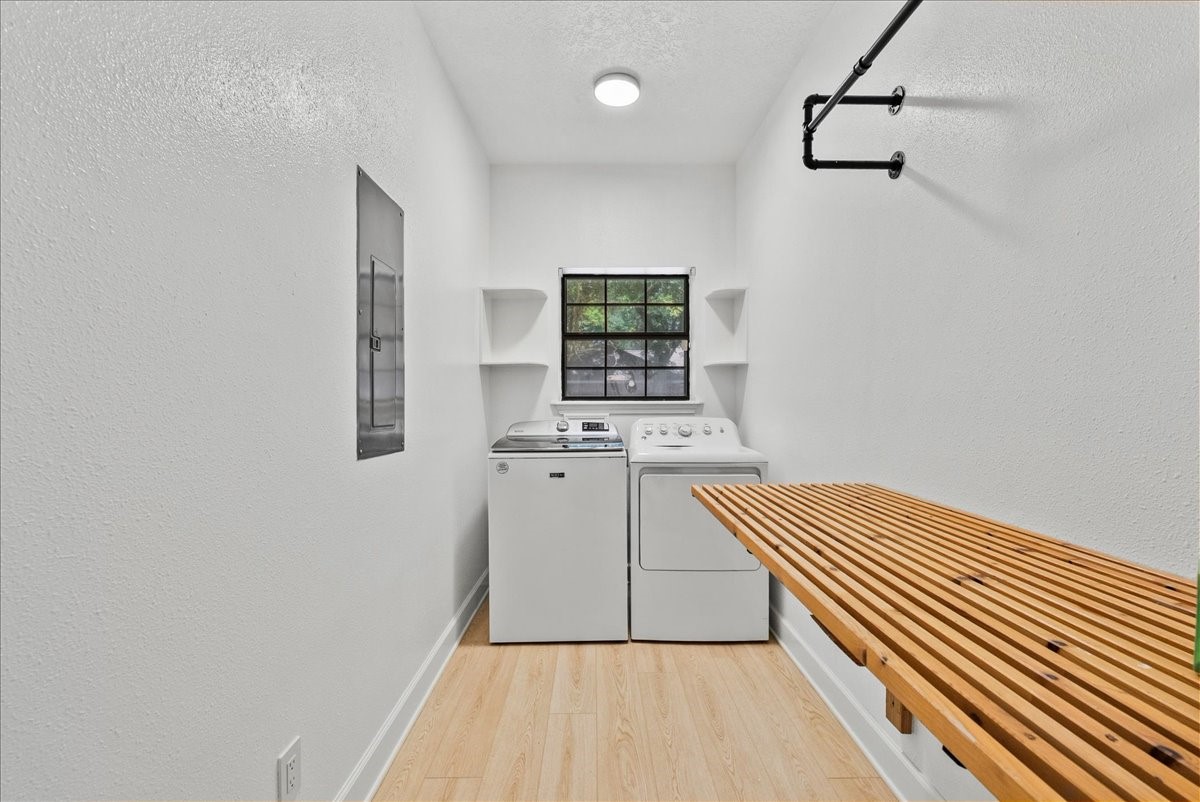 Enjoy the convenience of a large indoor laundry space with abundant natural light, a dedicated hanging area, and folding shelf that brings both function and style to your daily routine.