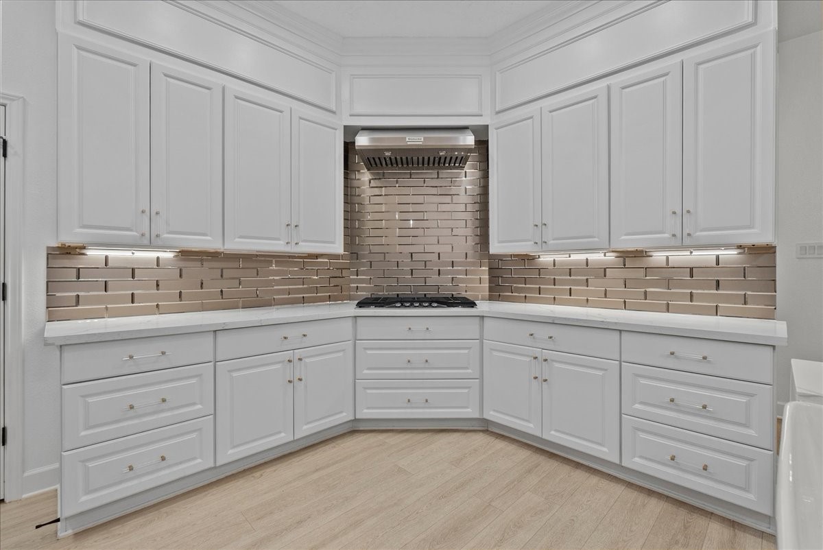 Luxury is found in every detail, from the rich gold hardware and fixtures to the sleek gold subway tile backsplash, creating a sophisticated yet inviting atmosphere.
