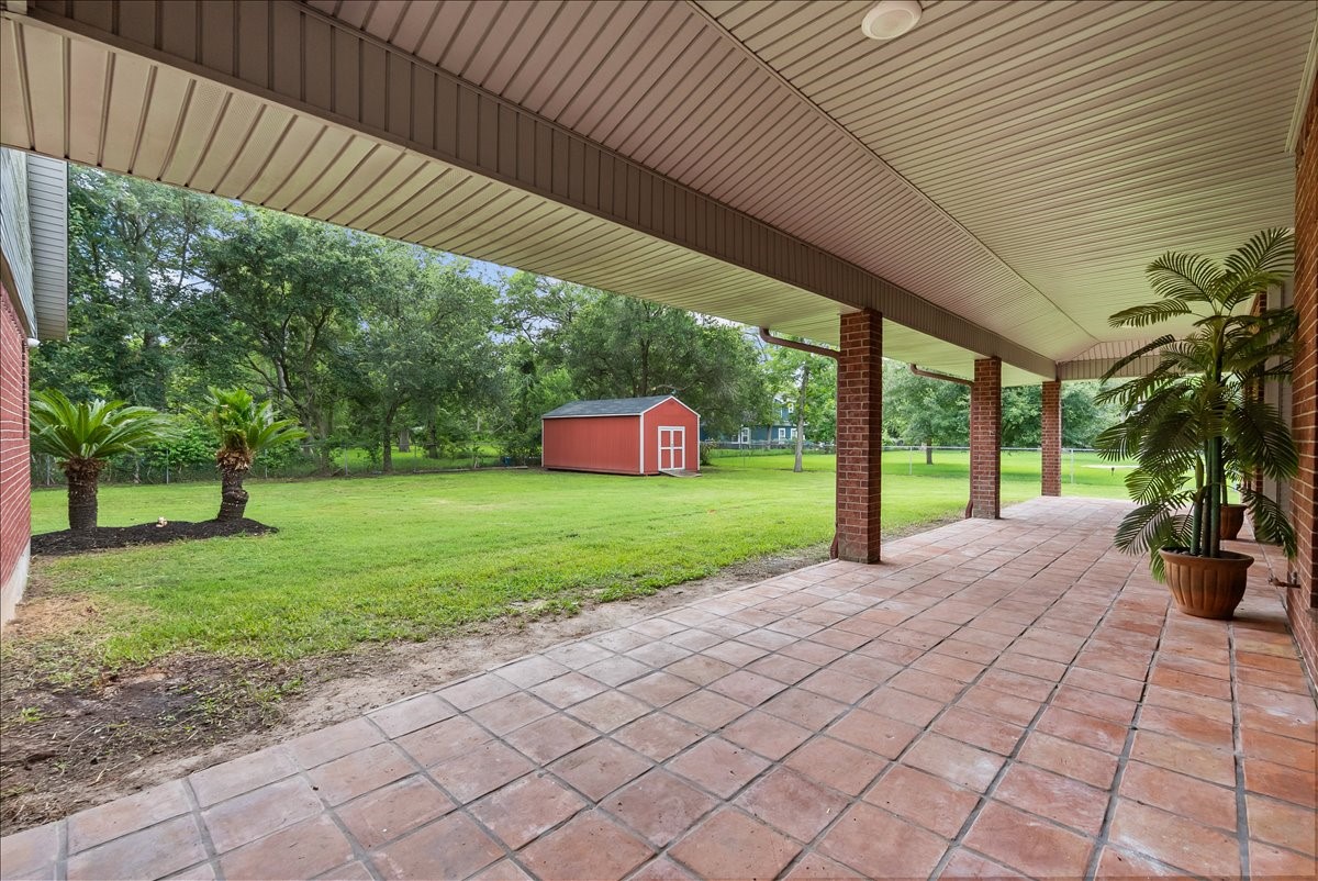 An entertainers dream awaits with an extra-large covered porch spanning the length of the home, offering the perfect space for relaxing or gatherings. Enjoy the added convenience of a storage shed and cozy up around the brick firepit for unforgettable evenings outdoors.