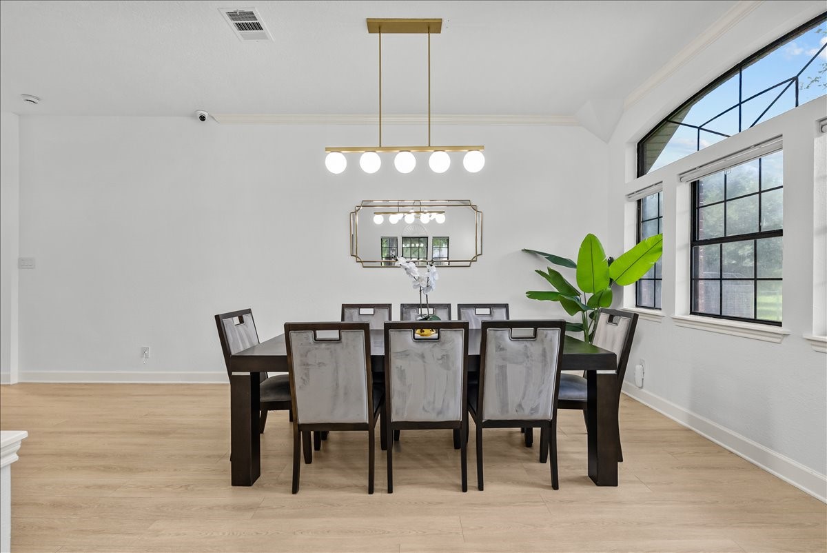Host memorable dinners beneath an elegant gold-accent pendant that brings warmth and sophistication to the formal dining room.