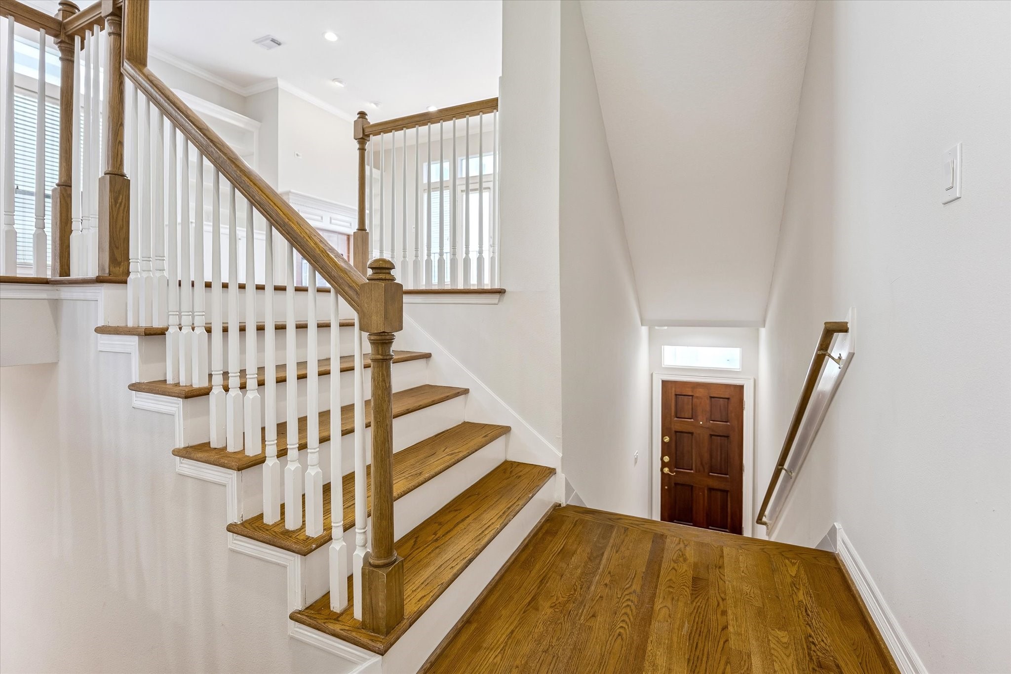 Light & Bright! Entry stairwell leads to 2nd floor living but also down adjoining stairs to 1st floor bedroom & ensuite, and garage access!