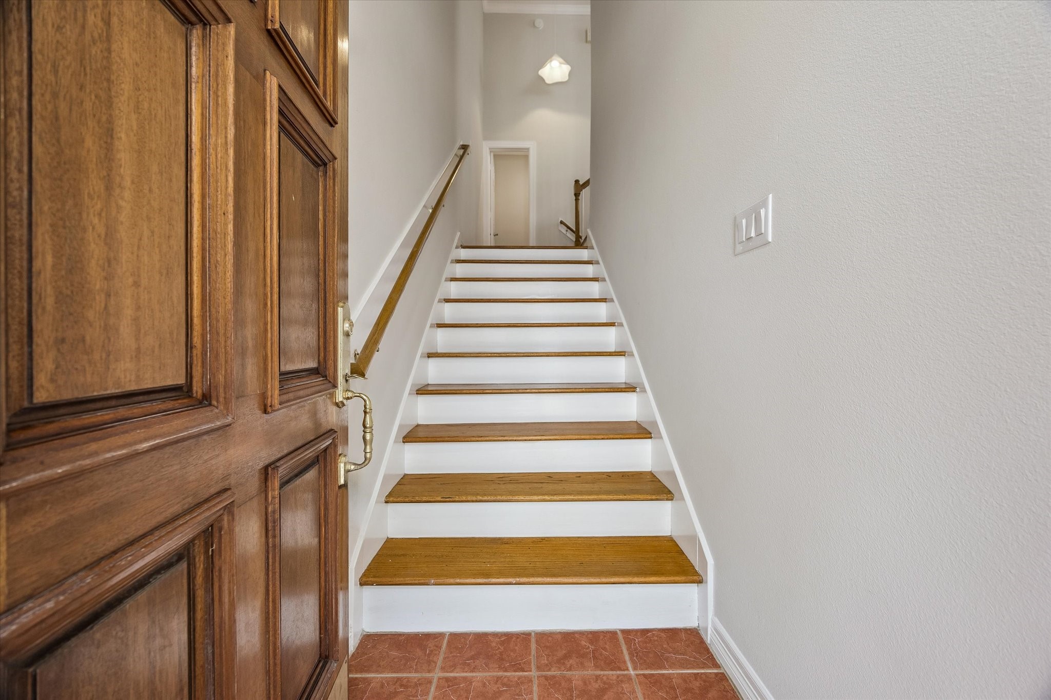 Beyond solid wood door is entry stairwell!