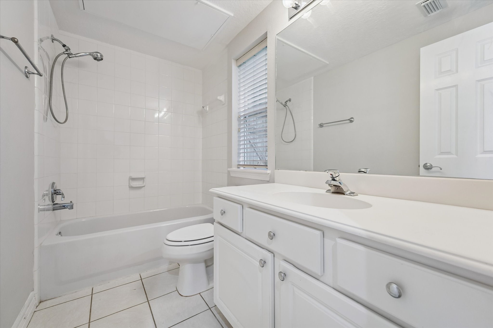 Cute & tidy! Tub and shower combo with even a little window for natural light and fresh air! Good-sized countertop here as well!