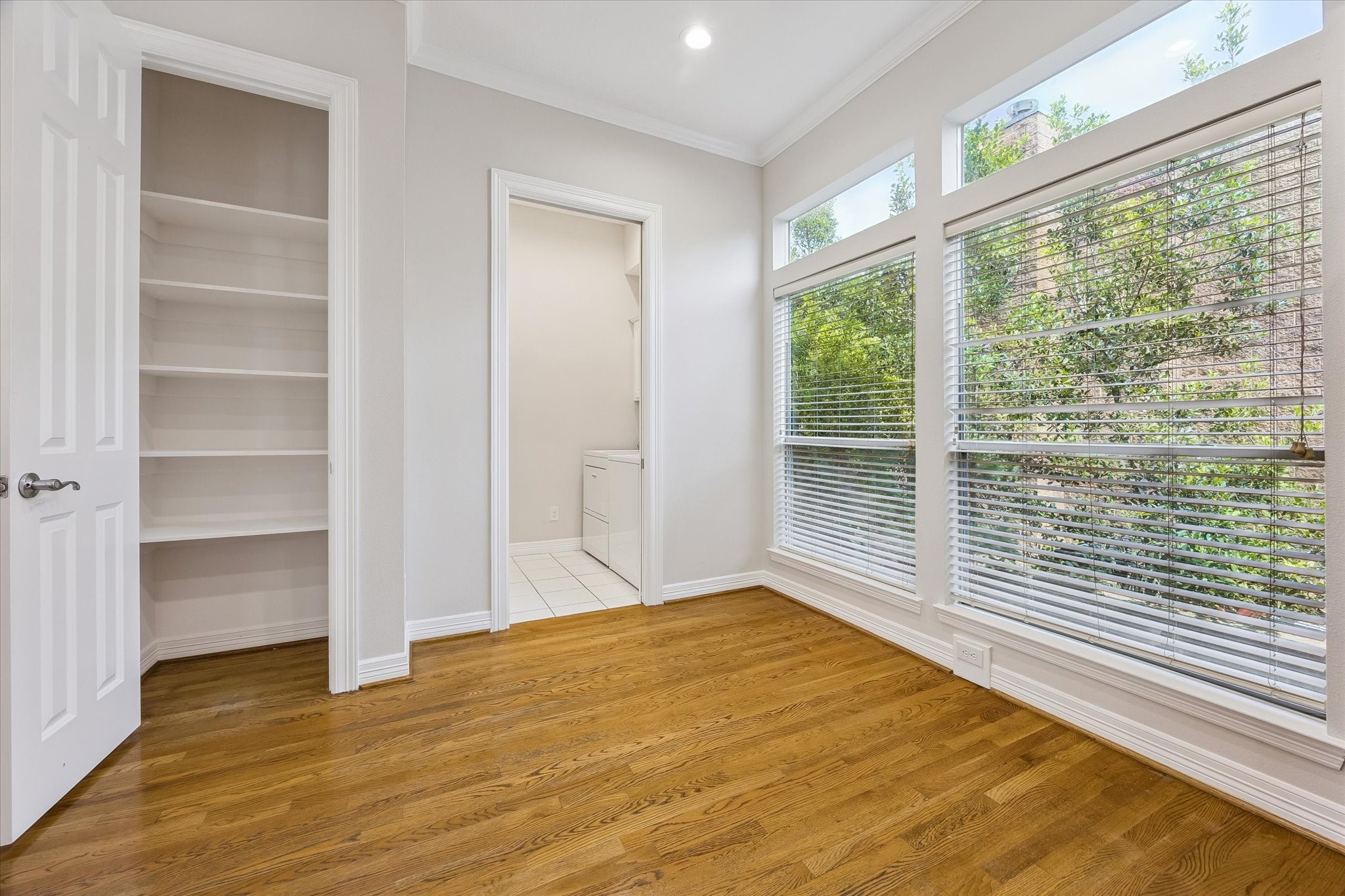 Pantry and laundry room conveniently located! Windows look out to neighboring trees!