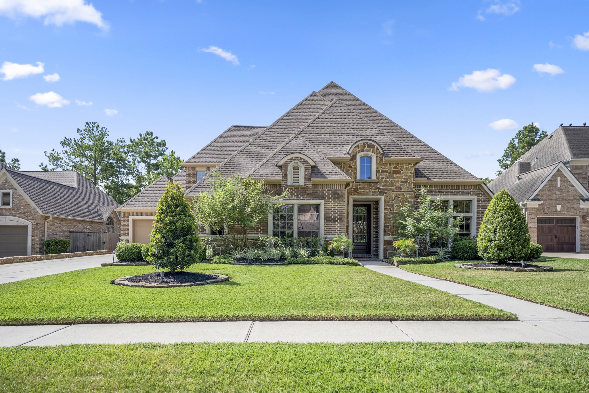 Welcome to 2407 Hendricks Lakes Drive in gated Lakes of Cypress Forest, where manicured landscaping and a brick-and-stone exterior create a polished first impression. Welcome to 2407 Hendricks Lakes Drive in gated Lakes of Cypress Forest, where manicured landscaping and a brick-and-stone exterior create a polished first impression.