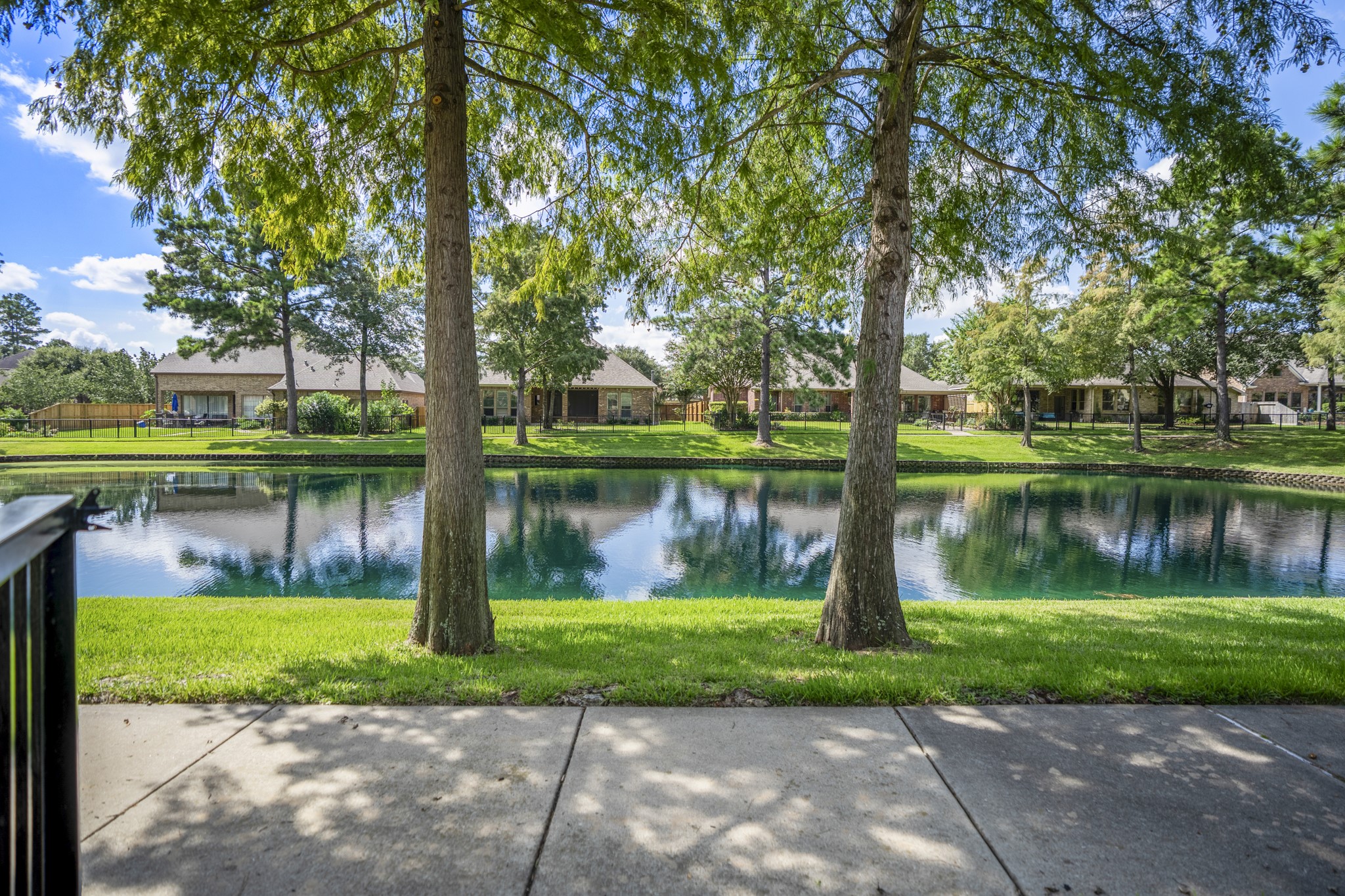 From the trail just beyond the backyard, the Lakes of Cypress Forest setting feels peaceful and scenic, with water views, mature trees, and green space stretching along the path. This is the lifestyle piece buyers can feel outside the fence line  morning walks, shaded views, and a water-front backdrop that extends the backyard experience into the neighborhood.
