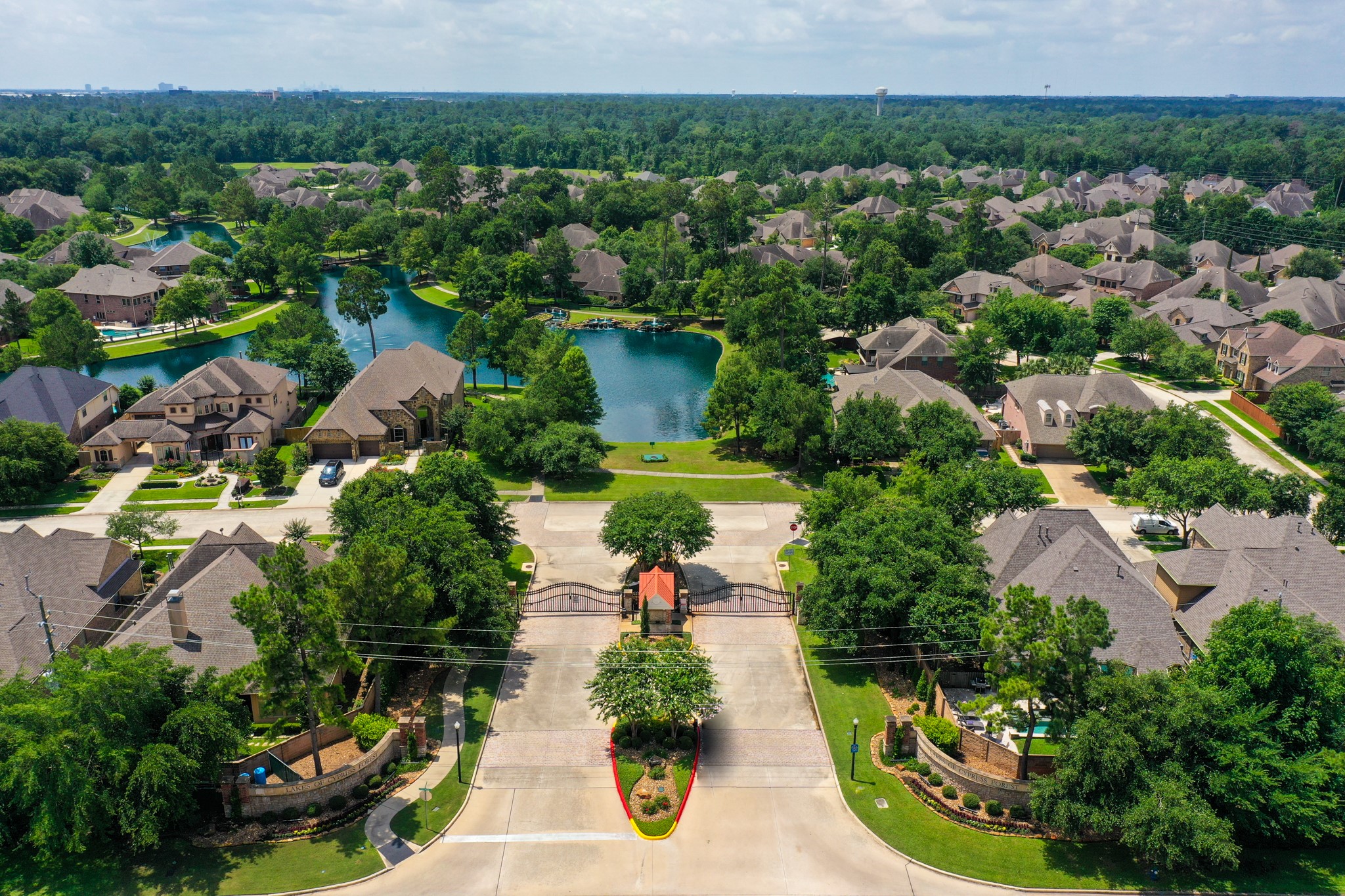 From above, Lakes of Cypress Forest shows off its gated entrance, lake-centered layout, and wooded surroundings, giving buyers a better feel for the setting before they ever reach the home. Winding streets, fountains, walking paths, and green space all reinforce the neighborhoods scenic, connected lifestyle just minutes from Spring conveniences.