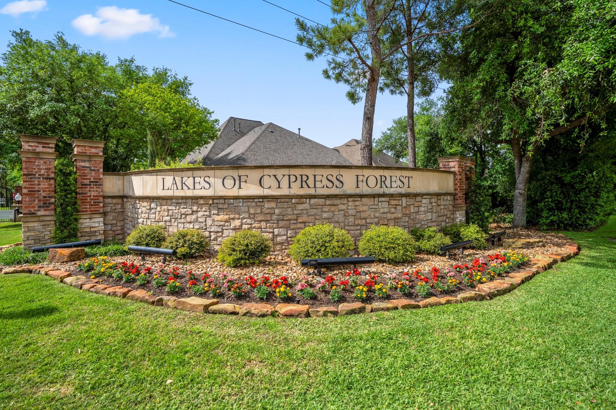 Lakes of Cypress Forest welcomes you with manicured landscaping, brick-and-stone signage, and an established gated-community feel before the neighborhood opens into its lakes, walking paths, fountains, pool, clubhouse, and outdoor amenities. Its the kind of setting that makes the water-front lifestyle feel connected from the moment you arrive.