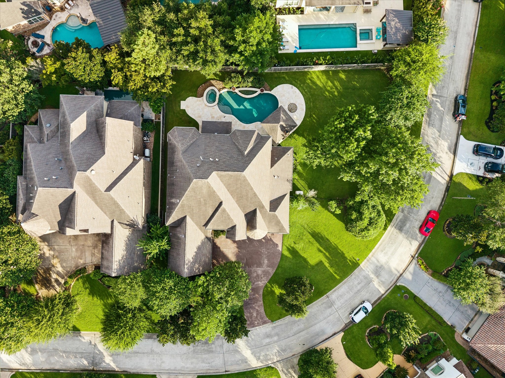 A stunning aerial perspective showcasing the exceptional setting of 35 N Fremont Ridge Loop, where mature trees, expansive outdoor spaces, and a resort-style pool and spa create a private retreat in the heart of Creekside Park.