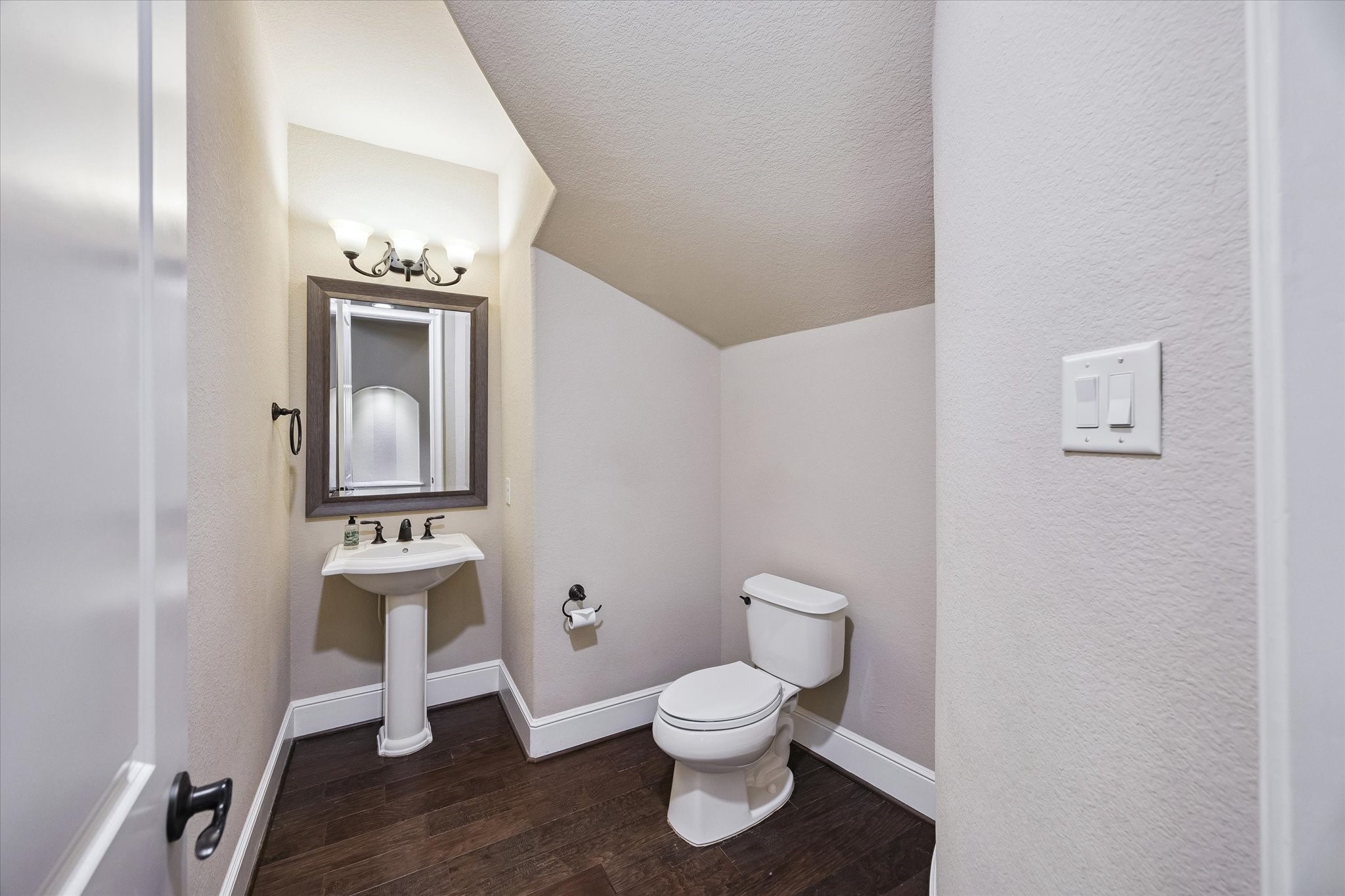 Beautifully appointed, the main-level powder room provides a convenient and elegant space for guests, reflecting the home's attention to detail throughout.