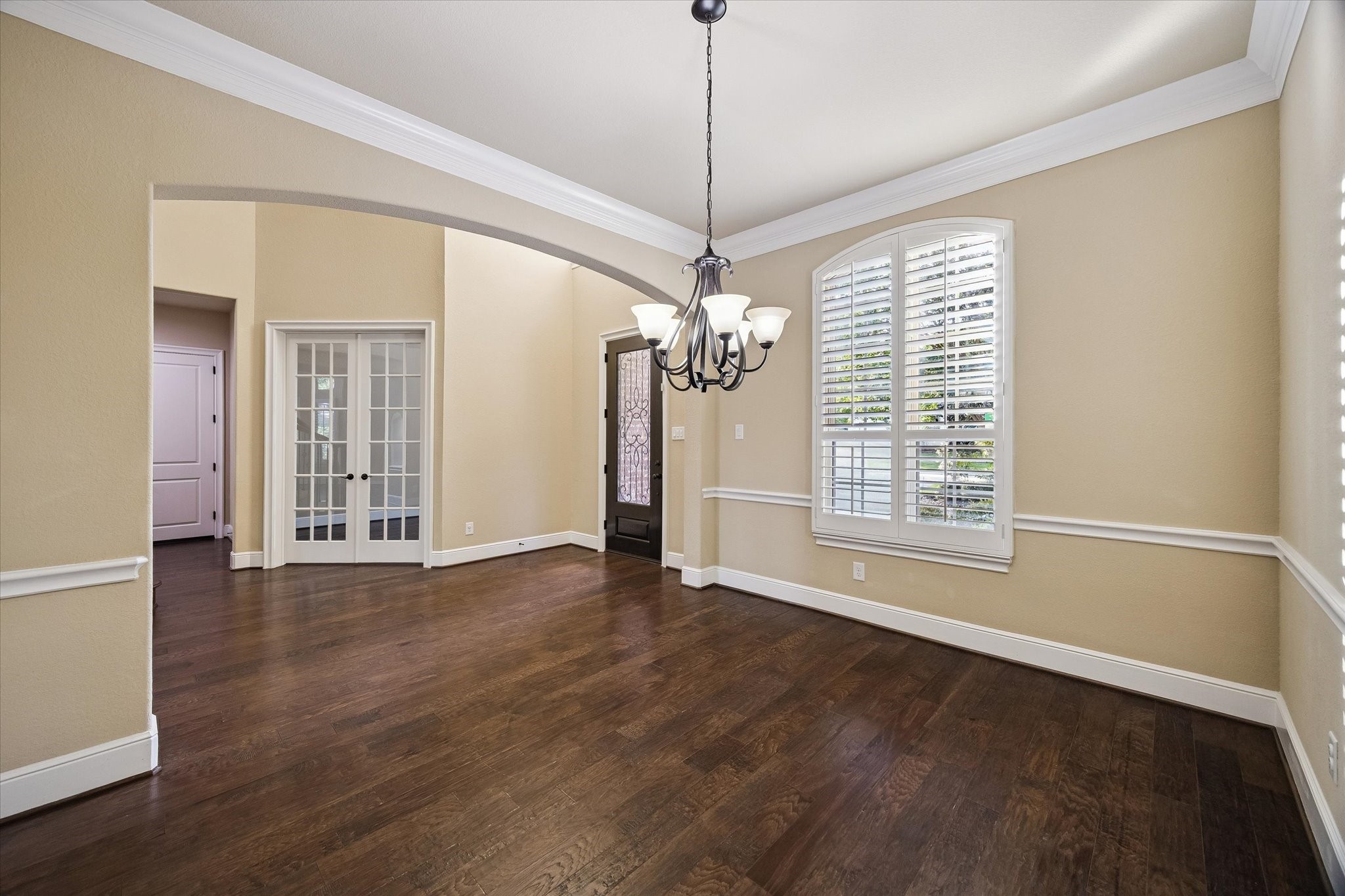 Designed for memorable gatherings, the formal dining room showcases rich hardwood floors, elegant crown molding, plantation shutters, and a warm, welcoming ambiance filled with natural light. Designed for memorable gatherings, the formal dining room showcases rich hardwood floors, elegant crown molding, plantation shutters, and a warm, welcoming ambiance filled with natural light.
