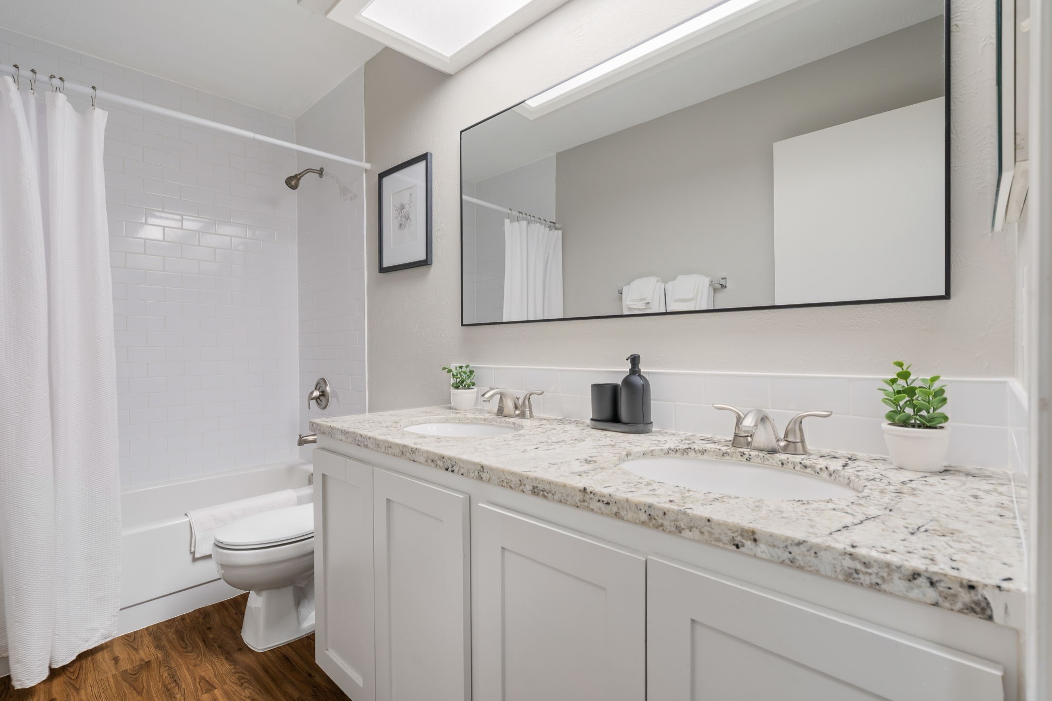 Secondary bathroom with two sinks.