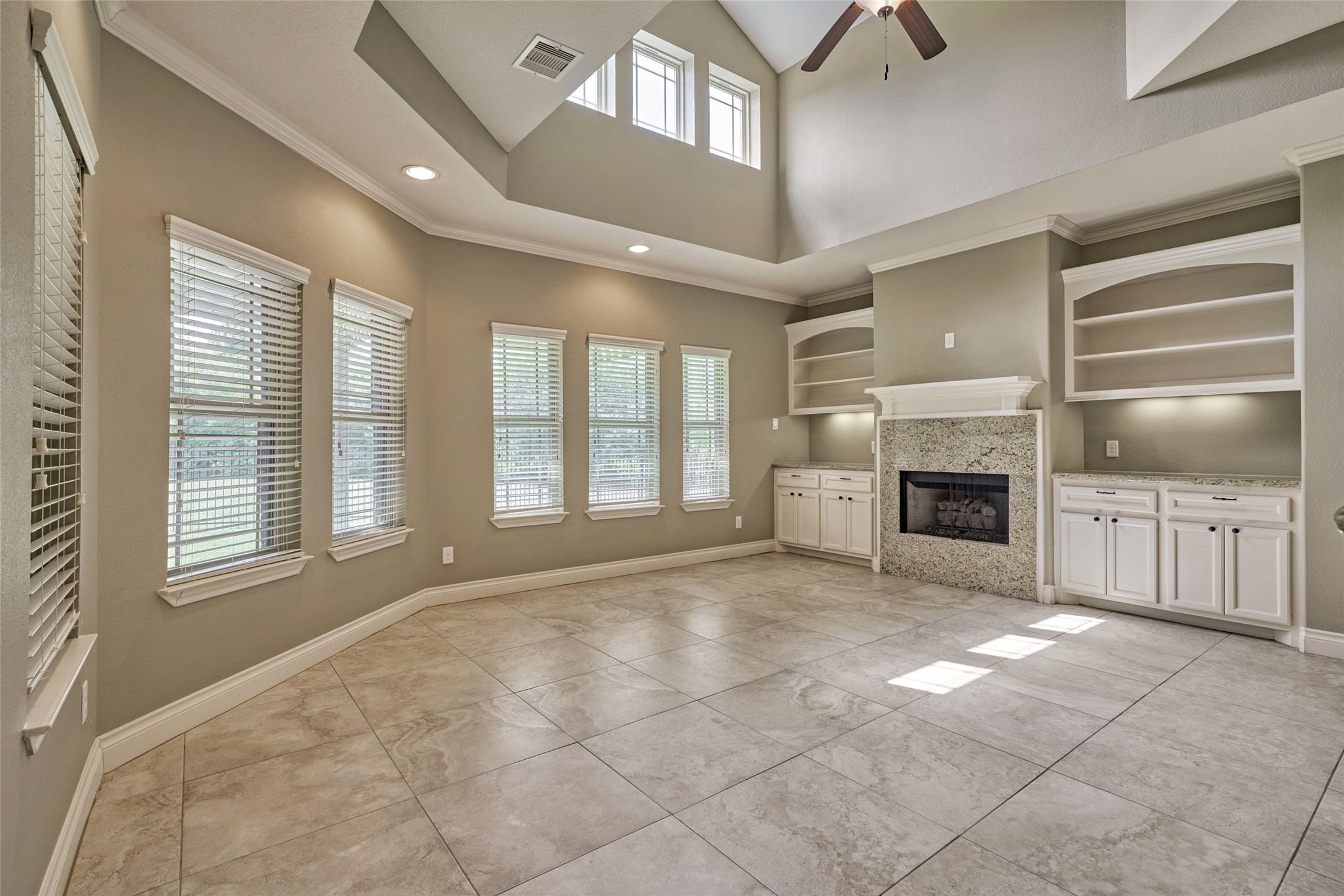 Nice architectural features in this townhome! A wall of windows, toasty fireplace and custom built-in cabinetry.