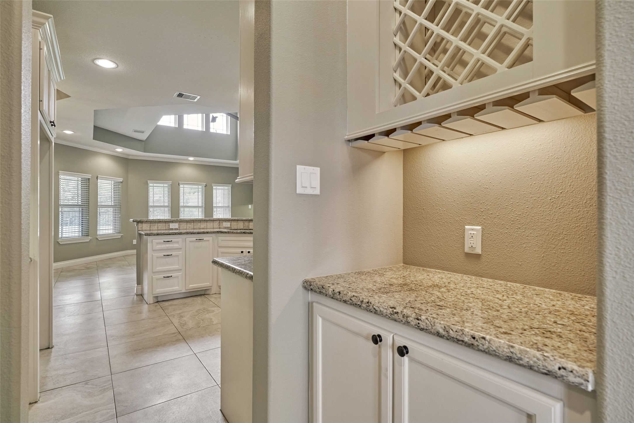 Passing from the dining room to the kitchen is a butler's pantry complete with wine rack.