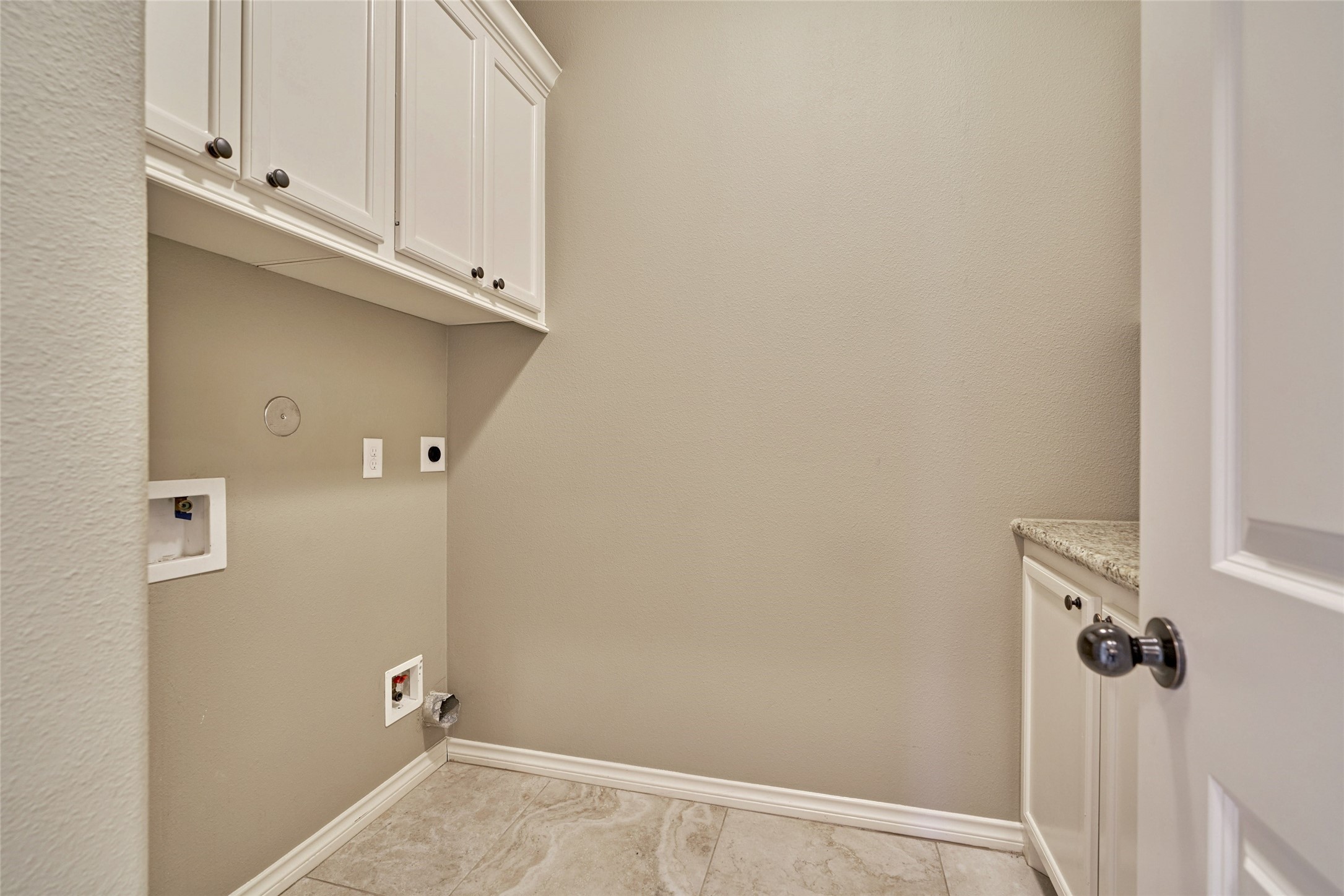Laundry room with ample storage.