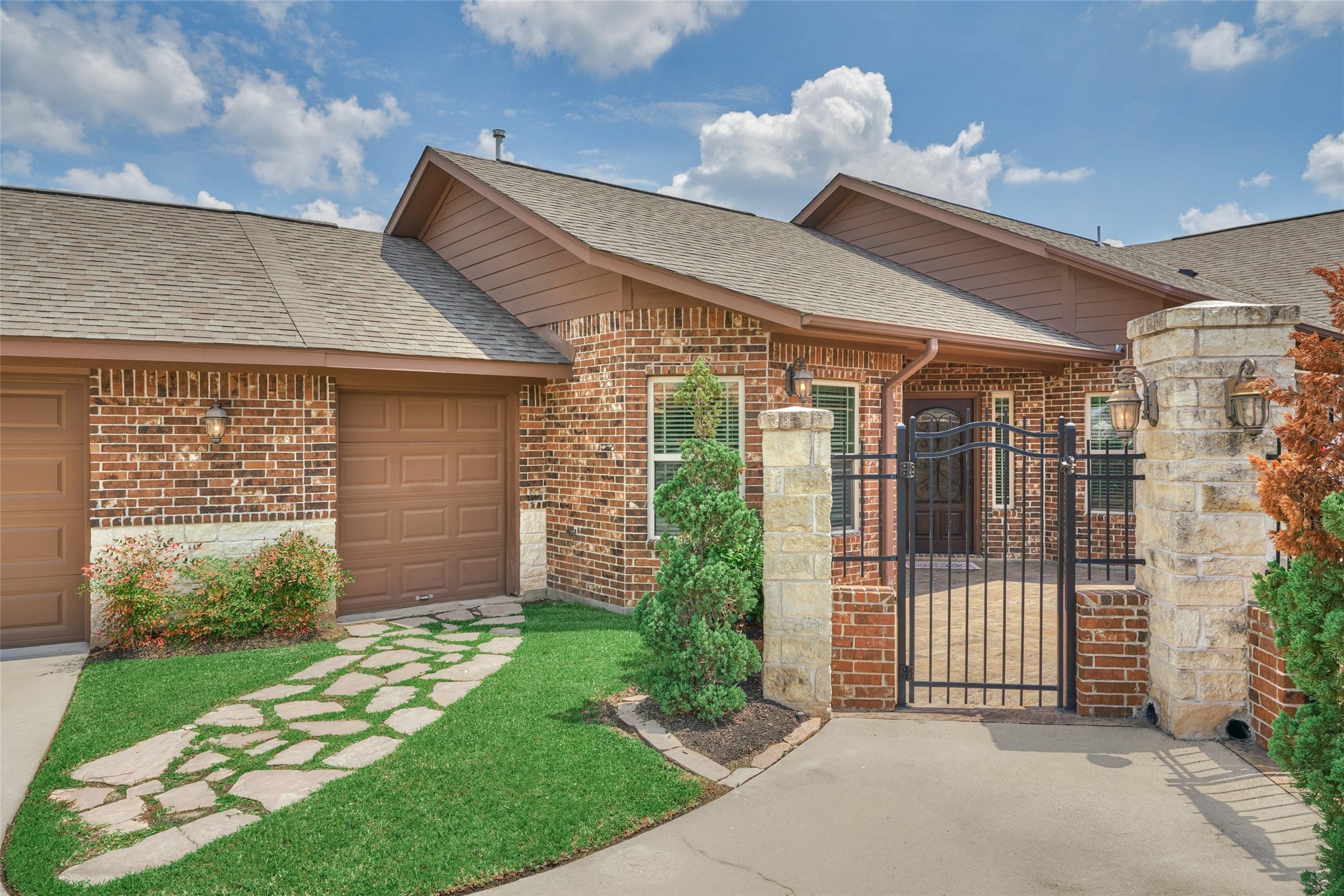 Gated entrance into the private courtyard. To the left of the gate is a stone pathway to the golf cart garage. Gated entrance into the private courtyard. To the left of the gate is a stone pathway to the golf cart garage.