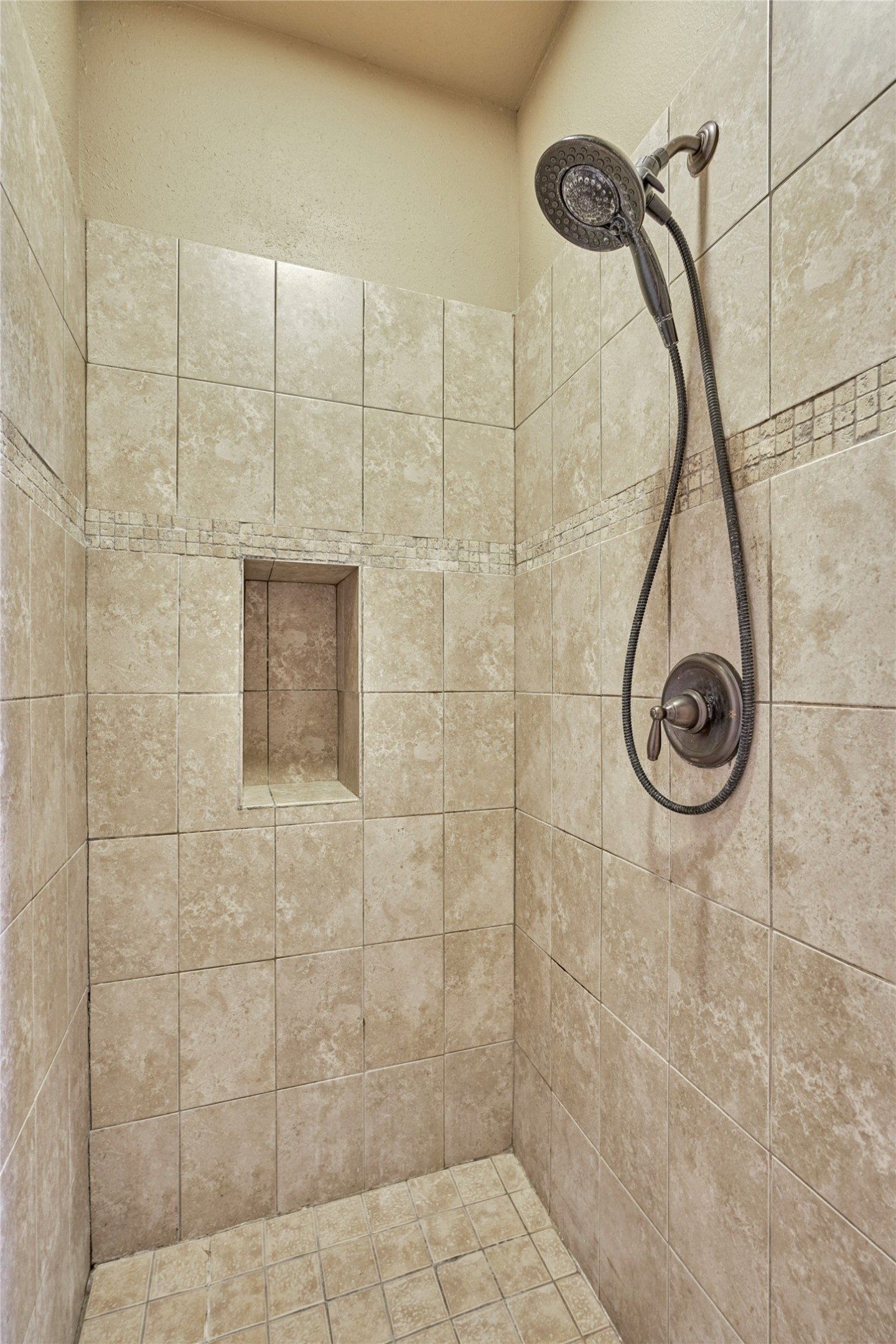 Walk-in shower with shampoo/soap niche.