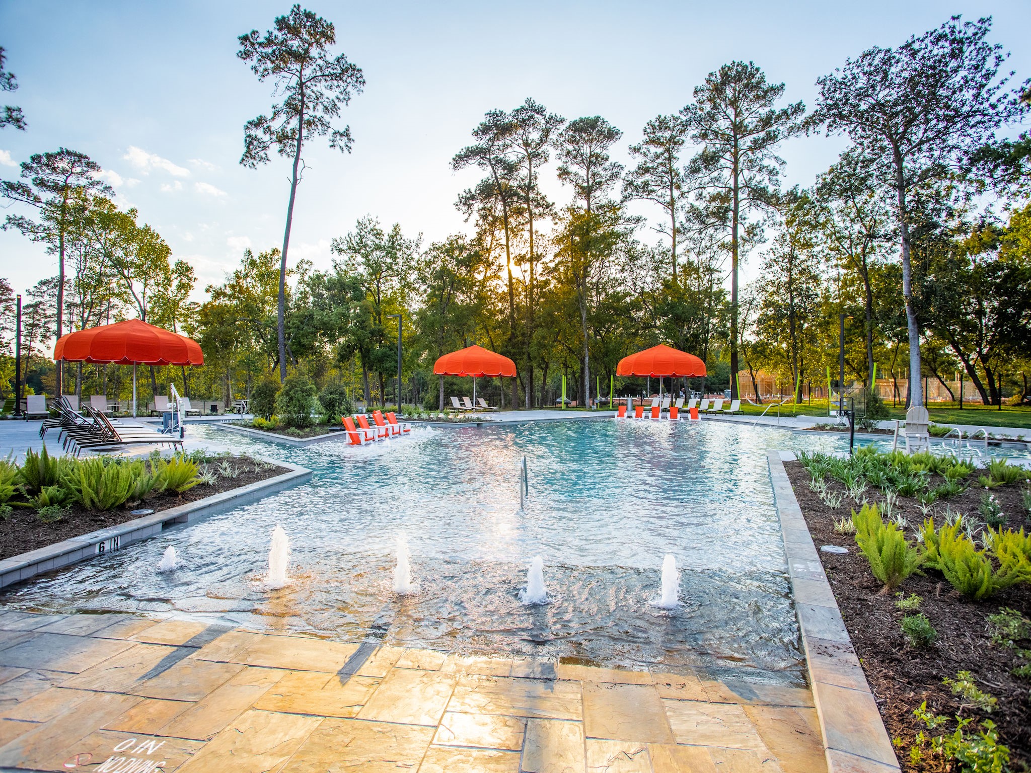 Residents are making a splash in the brand new resort-style pool at The Lake House amenity complex! The pool area includes hammocks and Adirondack chairs to hang, a basketball goal, picnic tables and beautiful lake views.