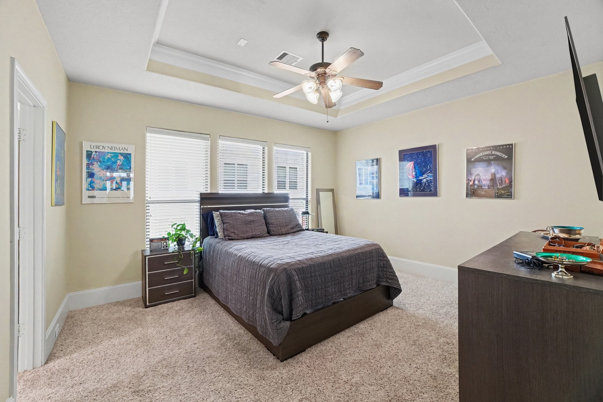 Large windows for natural light, coffered ceiling with fan. Step onto carpet when you get out of bed