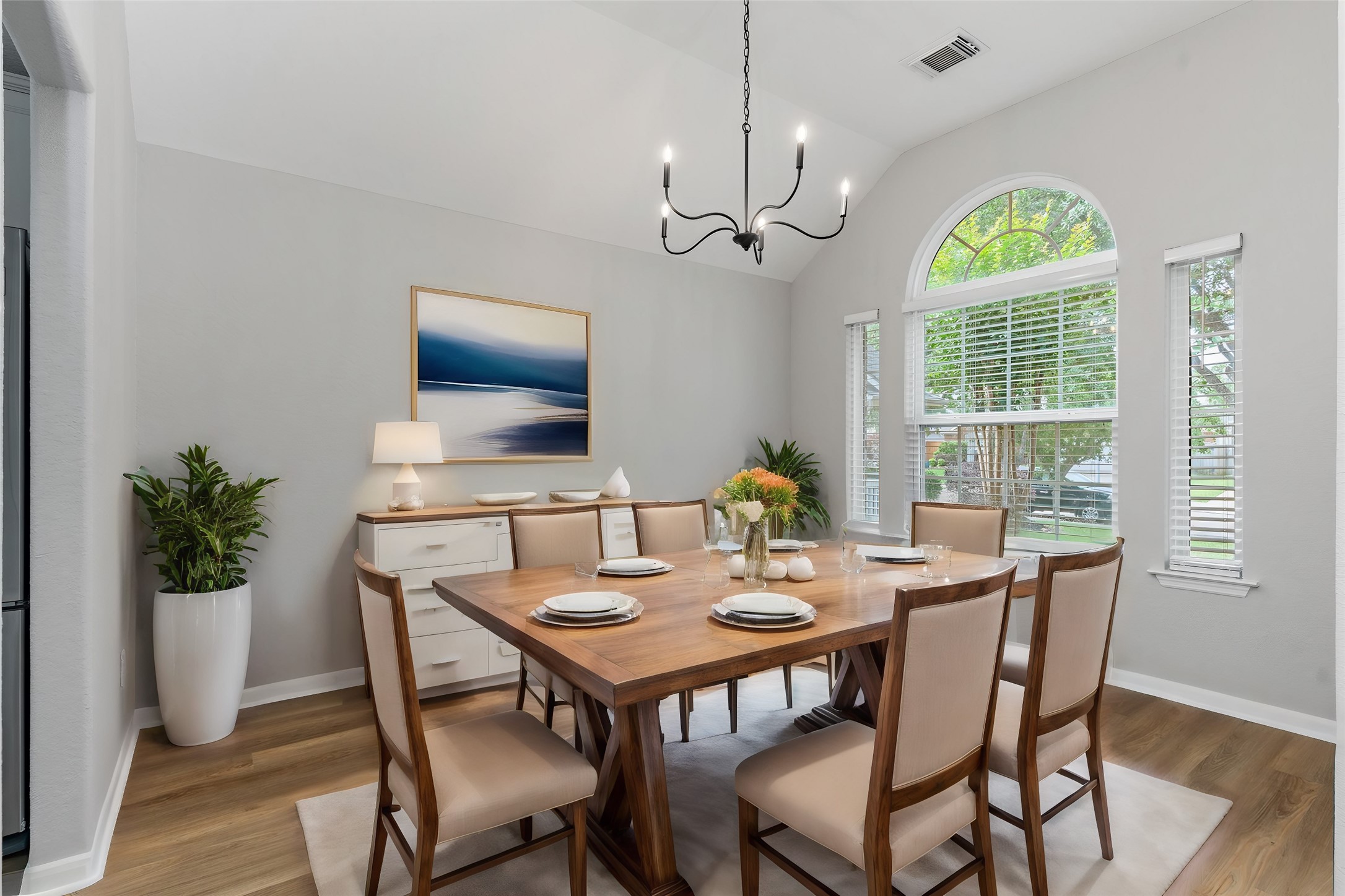 The elegant formal dining room boasts soaring ceilings and beautiful wood-look luxury vinyl plank flooring for easy maintenance. With direct access to the gourmet kitchen, serving family dinners and entertaining guests is effortless. Virtually Staged