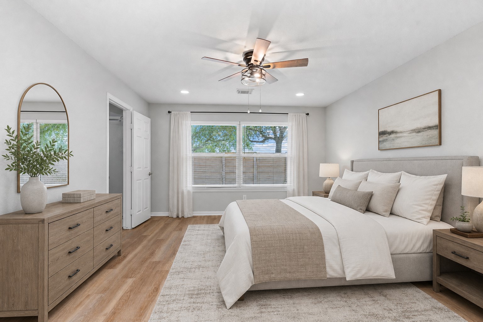 Retreat to the beautiful primary suite featuring soaring ceilings, stunning luxury vinyl plank flooring, and new energy-saving LED lighting that creates a warm and inviting atmosphere. This private owner's retreat offers the perfect place to relax and unwind at the end of the day. Virtually Staged