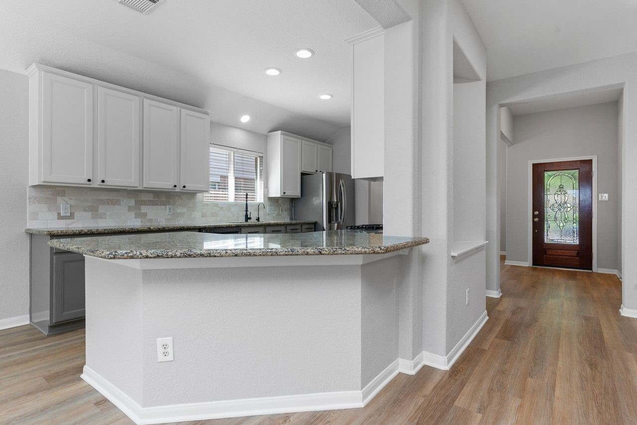 The gourmet kitchen showcases stunning granite countertops with upgraded bullnose edges, adding a custom touch of elegance. It's the perfect blend of style, durability, and functionality for everyday living and entertaining.