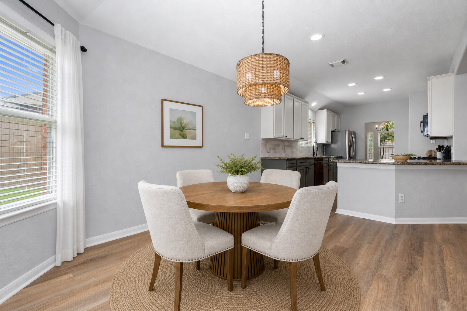 The casual dining area flows seamlessly into the gourmet kitchen, highlighted by beautiful new flooring that enhances the open-concept design. It's the perfect space for everyday living and entertaining family and friends. Virtually Staged