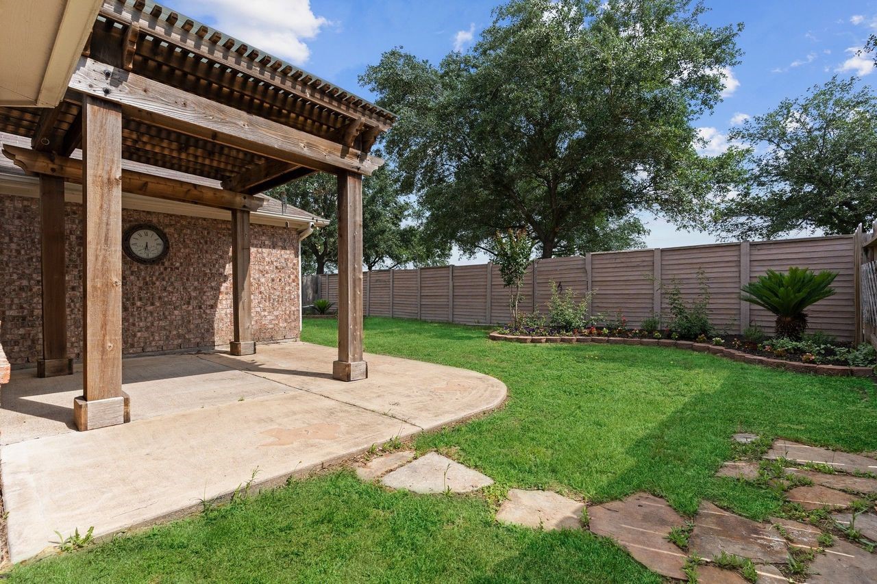 Enjoy your private backyard oasis featuring a wonderful, covered patiothe perfect place to relax, unwind, or entertain family and friends while taking in the peaceful surroundings.