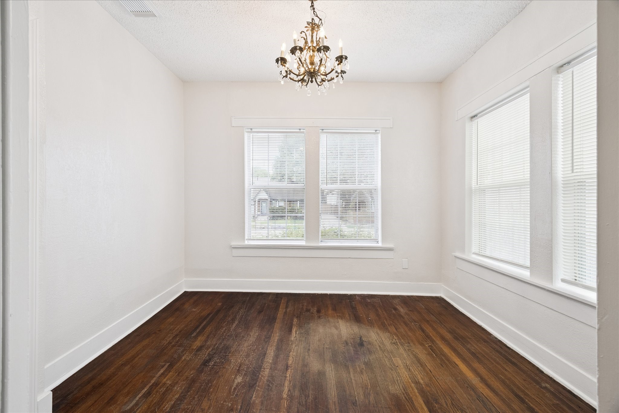 At home office, guest bedroom or sunroom with chic chandelier.