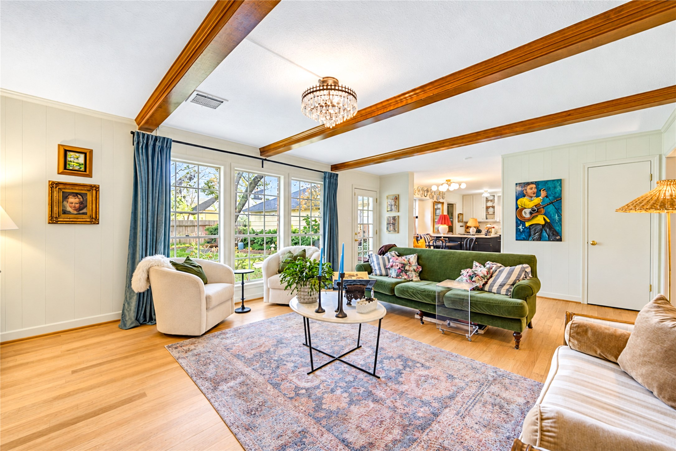 Step inside to a warm and inviting living space where soaring ceilings, exposed wood beams and beautiful wood floors create timeless character. Natural light pours through expansive windows, while the cozy fireplace and designer touches set the stage for relaxed evenings, effortless entertaining and making lasting memories. Step inside to a warm and inviting living space where soaring ceilings, exposed wood beams and beautiful wood floors create timeless character. Natural light pours through expansive windows, while the cozy fireplace and designer touches set the stage for relaxed evenings, effortless entertaining and making lasting memories.