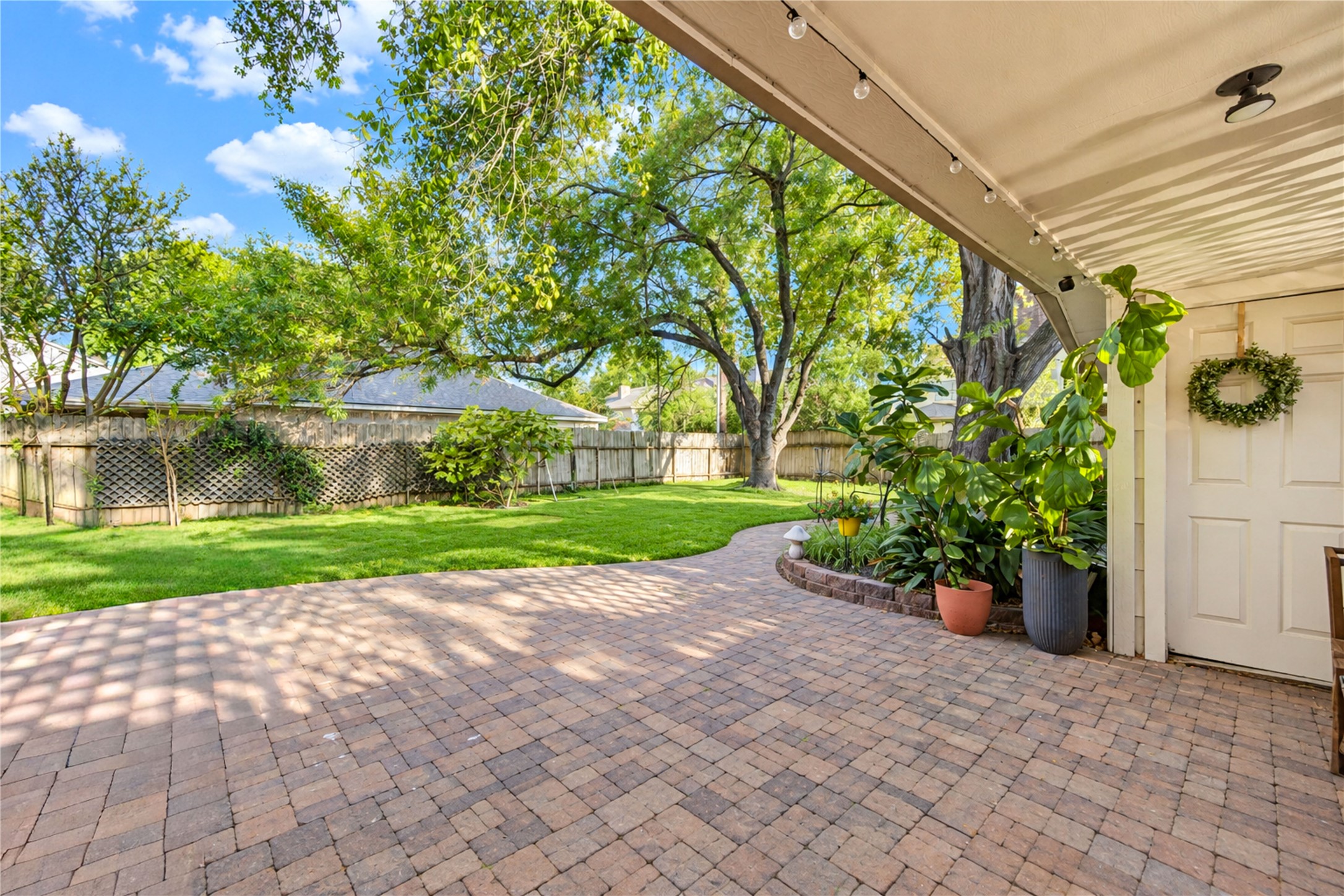 Step outside and embrace the beauty of outdoor living! This expansive brick paver patio offers endless possibilities for alfresco dining, morning coffee or relaxed weekend entertaining. With lush green lawn, mature shade trees and beautiful backyard views, this inviting space feels like a private retreat. Whether hosting a lively gathering or savoring a peaceful afternoon, there's plenty of room to enjoy the outdoors in comfort and style!