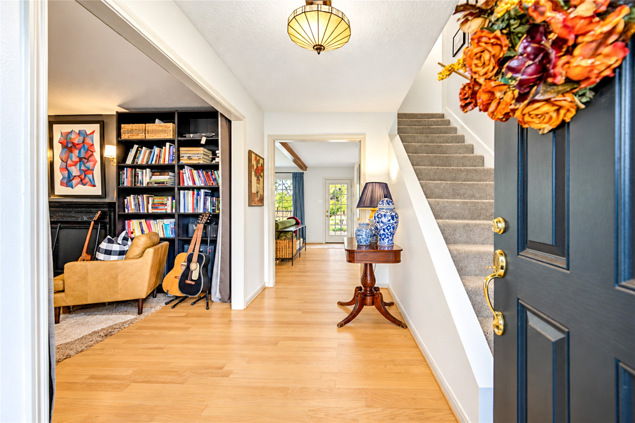 First impressions set the tone! Step inside to beautiful wood floors, a welcoming entry and thoughtfully curated designer touches that give this home its unique personality. Just off the foyer, a cozy study with floor-to-ceiling bookshelves offers the perfect escape for morning coffee, a favorite book or a quiet work-from-home retreat. A warm and inviting introduction to the spaces beyond! First impressions set the tone! Step inside to beautiful wood floors, a welcoming entry and thoughtfully curated designer touches that give this home its unique personality. Just off the foyer, a cozy study with floor-to-ceiling bookshelves offers the perfect escape for morning coffee, a favorite book or a quiet work-from-home retreat. A warm and inviting introduction to the spaces beyond!