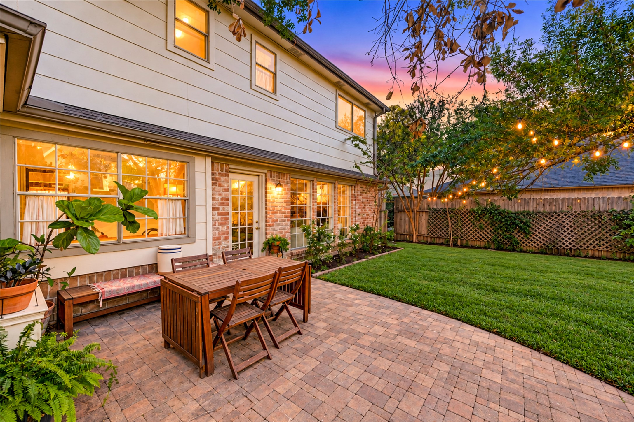 Your own backyard oasis awaits! This expansive brick paver patio creates the perfect setting for alfresco dining, weekend barbecues and memorable evenings under the stars. Surrounded by lush landscaping and mature trees, the inviting outdoor living space offers plenty of room to gather, relax and entertain. Imagine unwinding with a glass of wine as the sun sets and the patio lights create a warm, welcoming glow. Outdoor living at its finest!
