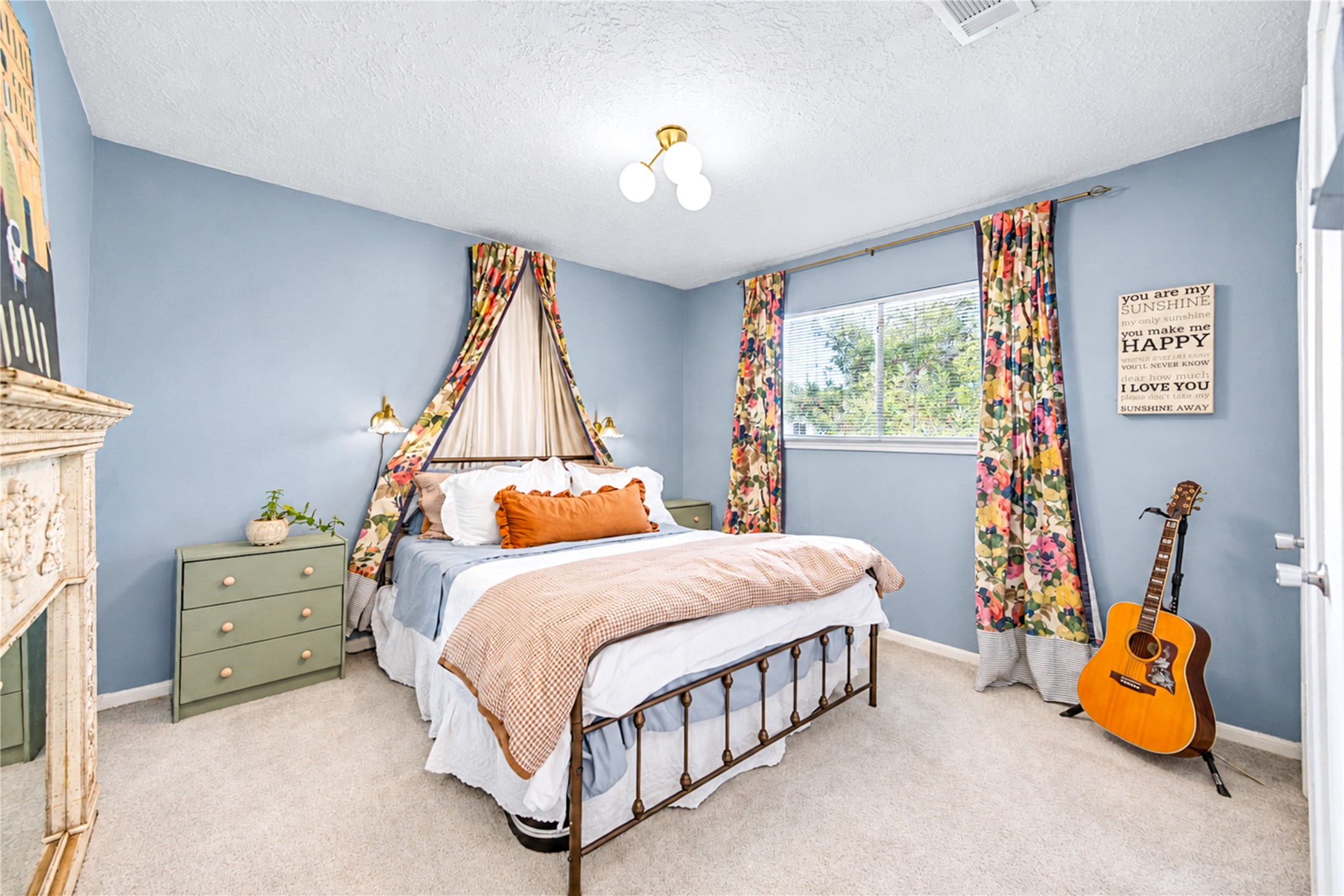 A charming retreat with personality to spare! This spacious second bedroom features soothing blue walls, abundant natural light and thoughtfully curated designer touches that create a warm, inviting atmosphere. With room to relax, recharge or express your personal style, this versatile second-floor bedroom offers a cozy escape that feels both comfortable and effortlessly stylish!