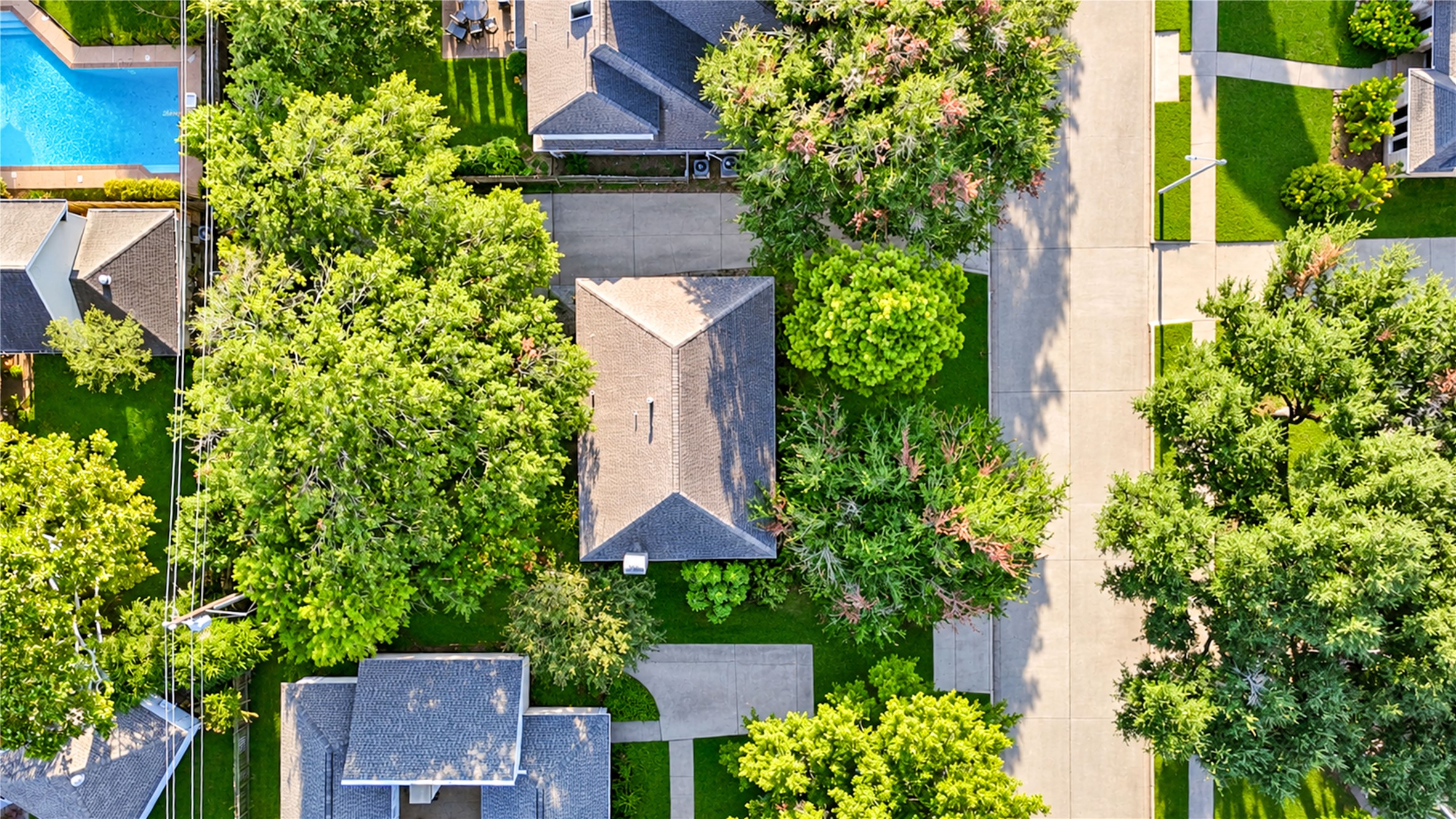 A beautiful perspective from above! Surrounded by mature trees and lush greenery, this Village West home offers a peaceful setting with a spacious backyard and inviting outdoor living areas. The aerial view highlights the home's established neighborhood charm, where tree-lined streets and generous green spaces create a welcome escape from the everyday hustle. Enjoy the tranquility of neighborhood living in the heart of the Energy Corridor!