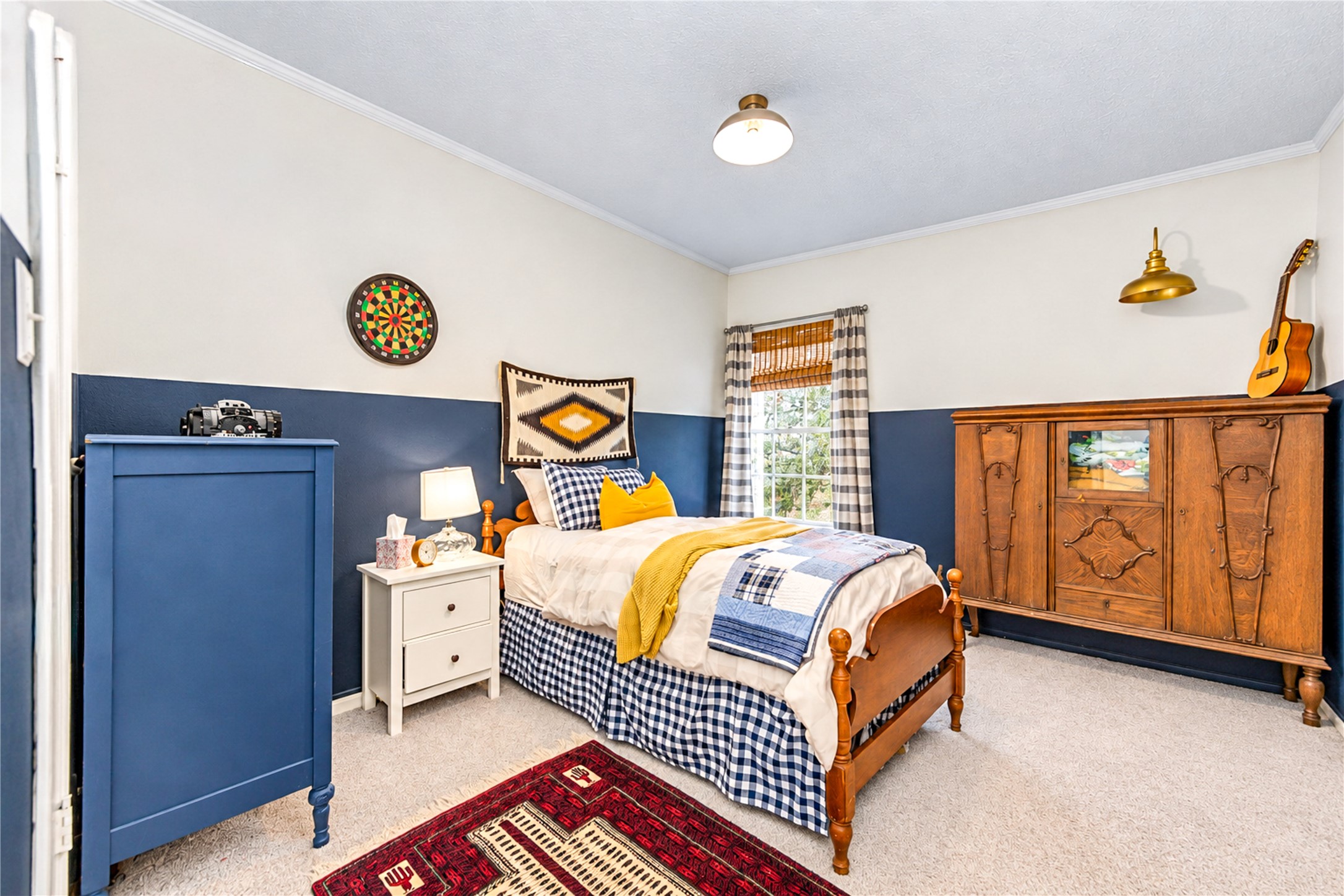 Full of charm and personality! This inviting fourth bedroom features a beautiful blue accent wall, soft carpeting and warm natural light. Thoughtful designer details create a cozy, welcoming atmosphere, while the versatile layout offers endless possibilities as a guest retreat, creative space or additional bedroom. Another delightful example of the character and style found throughout this home!
