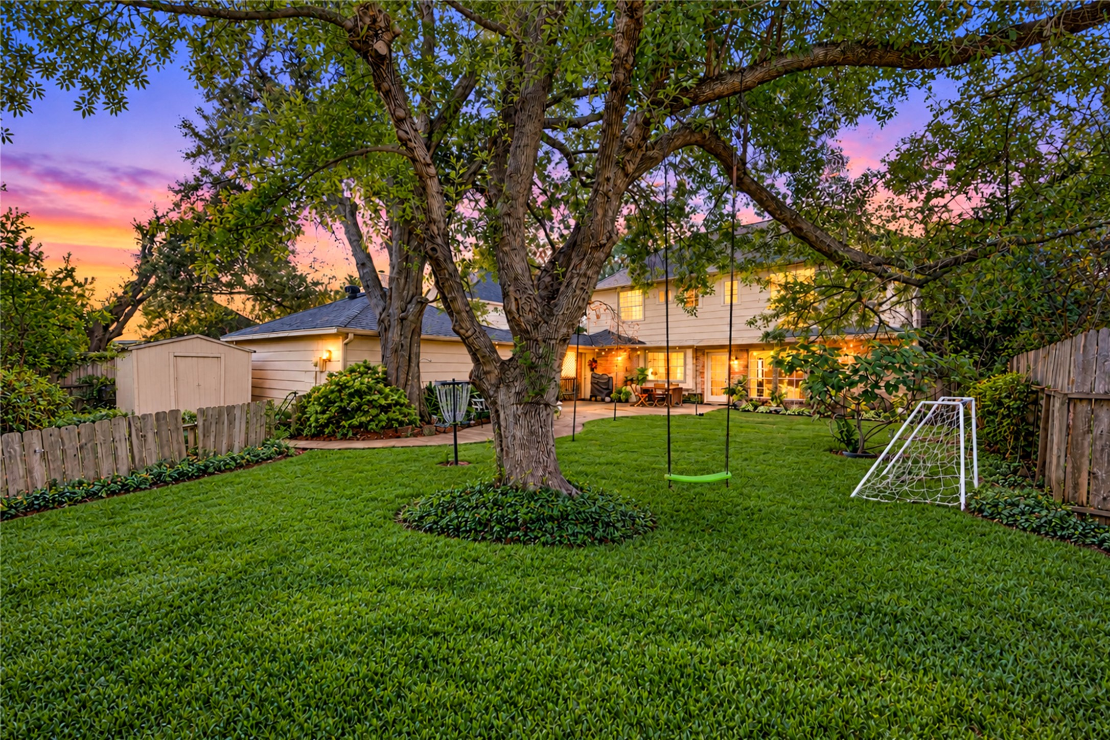 Escape the everyday in this peaceful backyard retreat! A magnificent mature shade tree takes center stage, creating a beautiful canopy over the lush green lawn. Surrounded by established landscaping and a privacy fence, this spacious outdoor setting invites lazy afternoons in the shade, weekend gatherings and quiet moments enjoying nature. A wonderful extension of the home's inviting indoor living spaces!