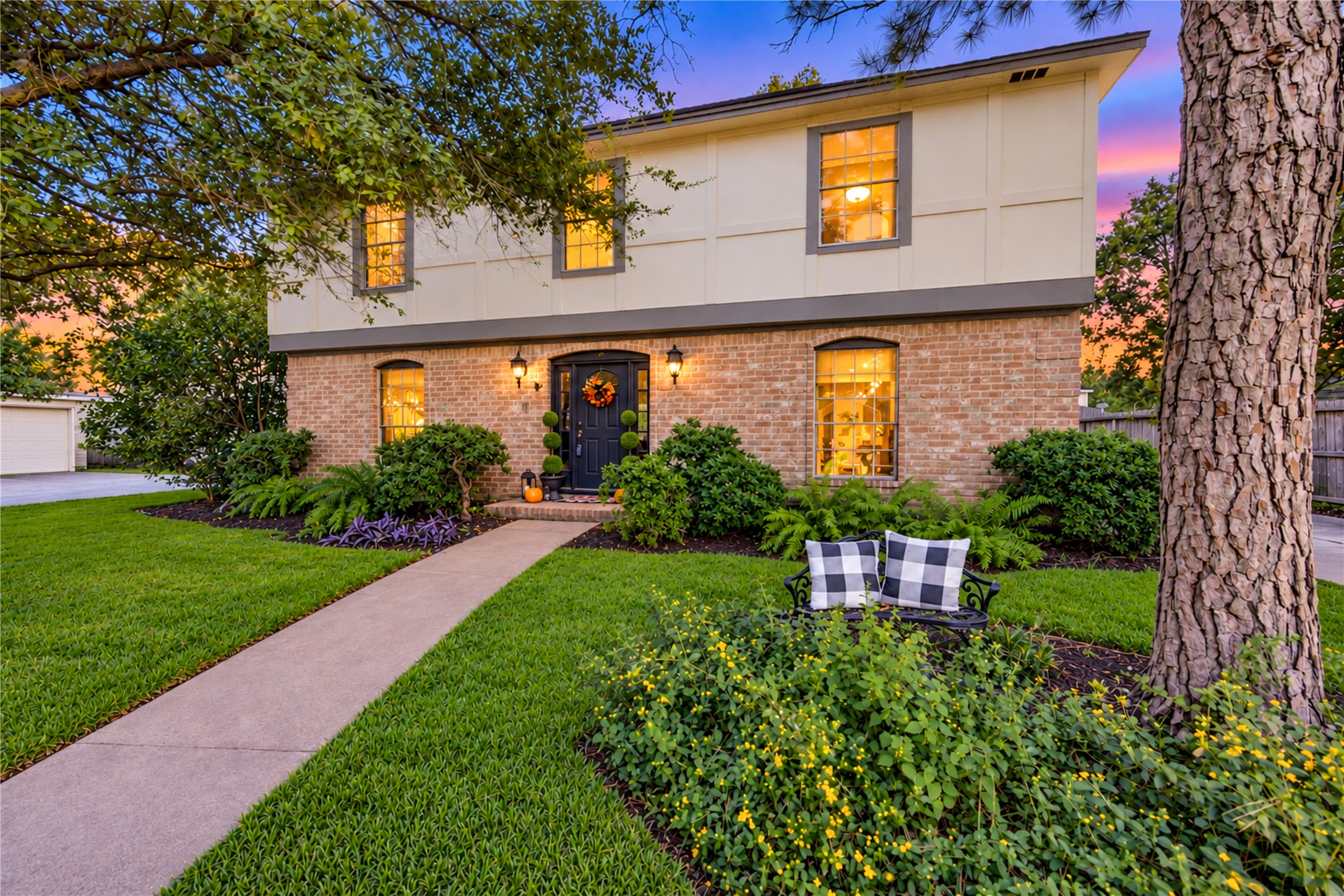 A warm welcome begins at the front door! Lush landscaping, a charming brick walkway and inviting entry create beautiful curb appeal, while the soft glow of evening lights sets the scene for coming home to your own peaceful retreat in Village West. A warm welcome begins at the front door! Lush landscaping, a charming brick walkway and inviting entry create beautiful curb appeal, while the soft glow of evening lights sets the scene for coming home to your own peaceful retreat in Village West.
