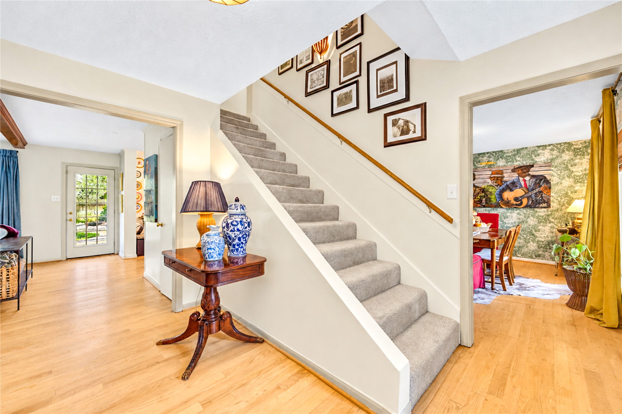 A welcoming entry with effortless flow! Beautiful wood floors, crisp neutral walls and a staircase accented with a charming gallery wall create a warm, inviting atmosphere. Thoughtful designer details add personality, while the open layout offers a natural connection to the home's comfortable living spaces. Every corner feels like home! A welcoming entry with effortless flow! Beautiful wood floors, crisp neutral walls and a staircase accented with a charming gallery wall create a warm, inviting atmosphere. Thoughtful designer details add personality, while the open layout offers a natural connection to the home's comfortable living spaces. Every corner feels like home!