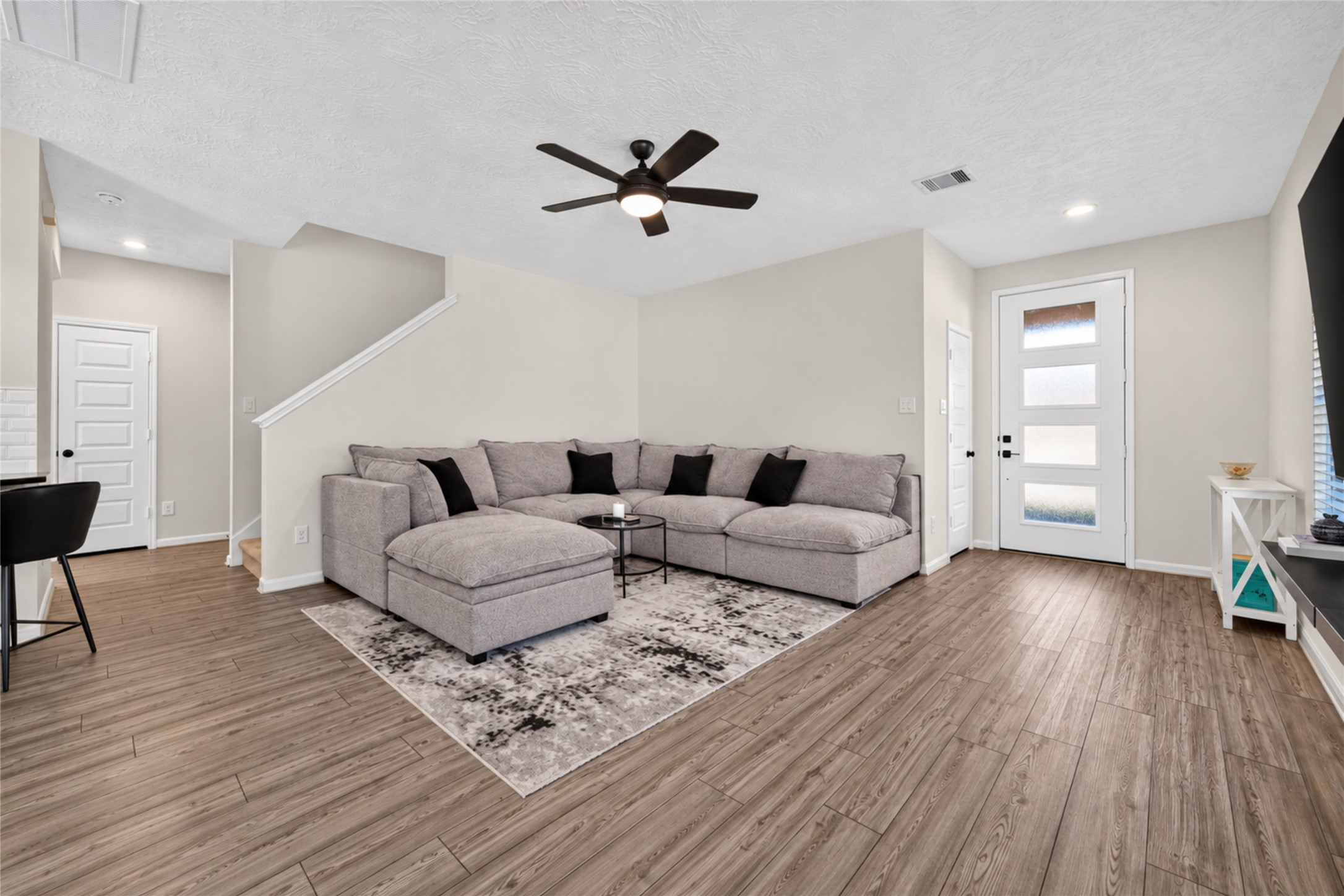Imagine settling into this comfortable living room after a busy day. The open layout, natural light, and attractive flooring create an inviting setting for relaxation and entertainment. Imagine settling into this comfortable living room after a busy day. The open layout, natural light, and attractive flooring create an inviting setting for relaxation and entertainment.