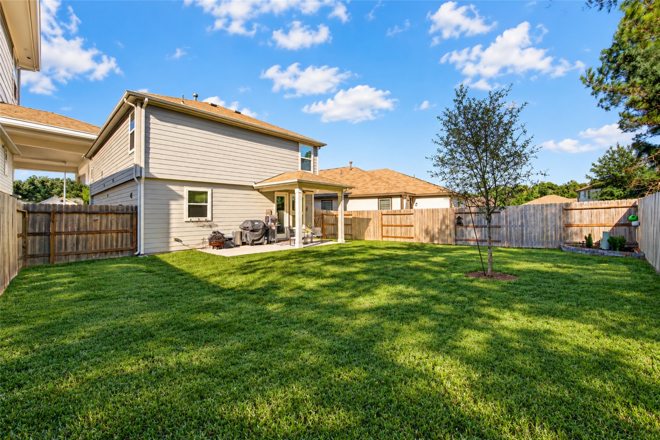 Enjoy the best of outdoor living with an extended covered patio overlooking the spacious fenced backyard.
