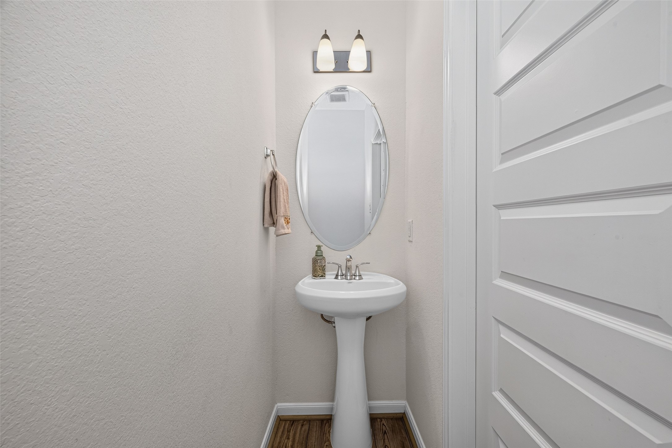 A conveniently located half bathroom adds comfort and practicality to the main level. Its accessible location makes entertaining guests and enjoying the downstairs living areas even easier.