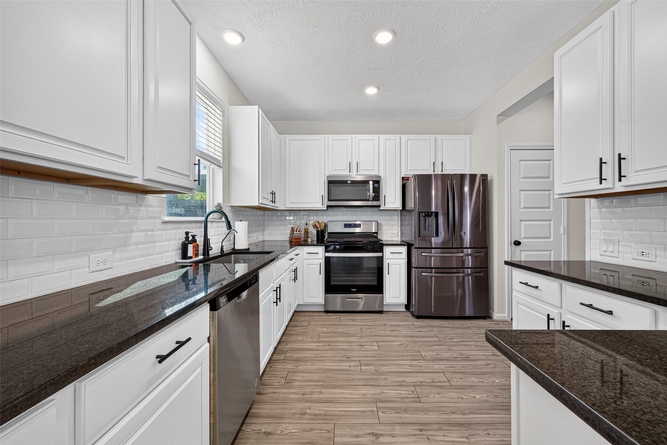Keep everything organized with abundant cabinetry and generous preparation space in this well-appointed kitchen. The thoughtful arrangement makes it easy to move between cooking, serving, and cleanup.
