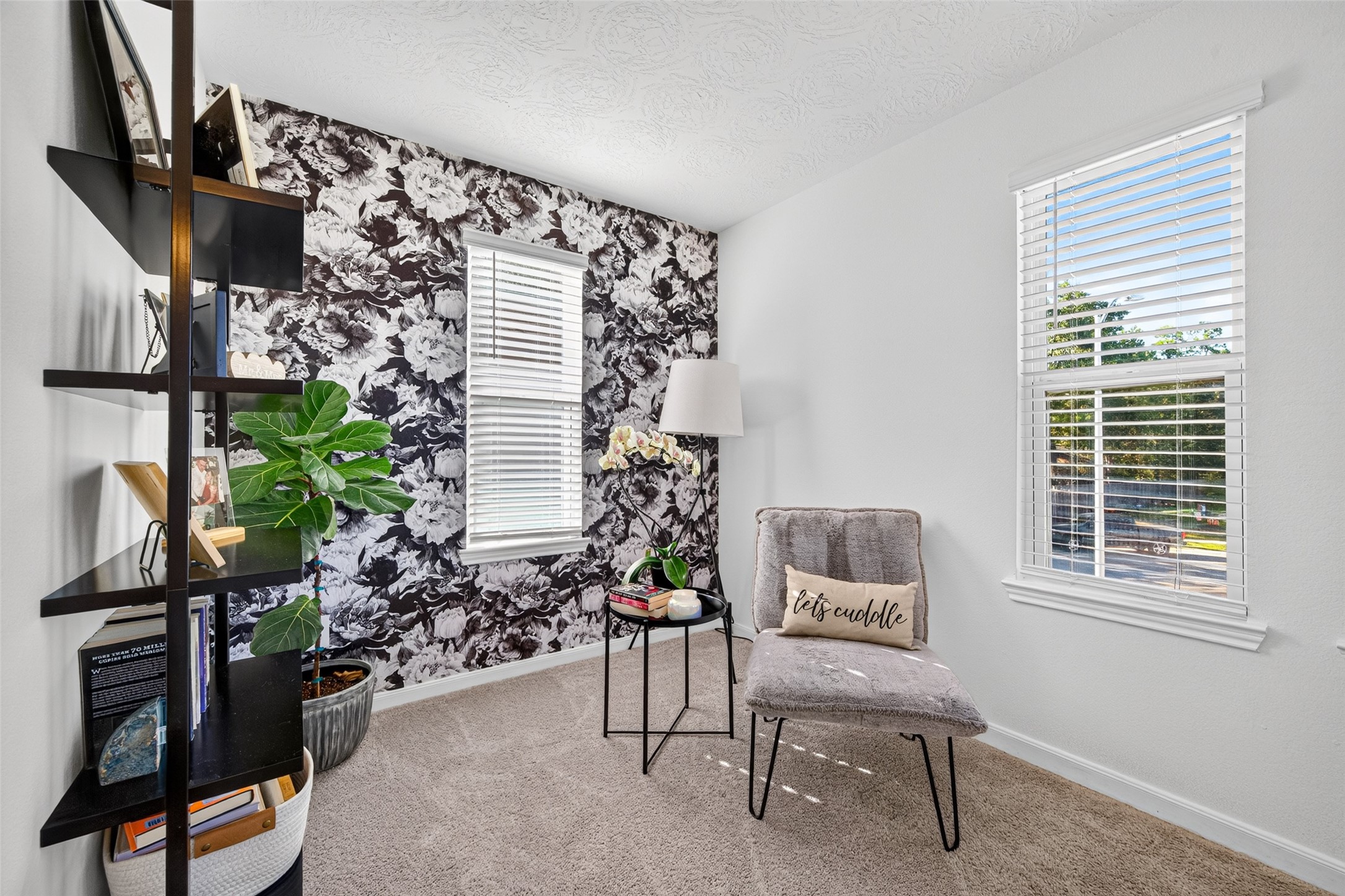 Discover a charming sitting area within the primary suite, complete with natural light and a decorative accent wall. Imagine transforming this space into a reading nook, relaxation corner, or personal retreat.