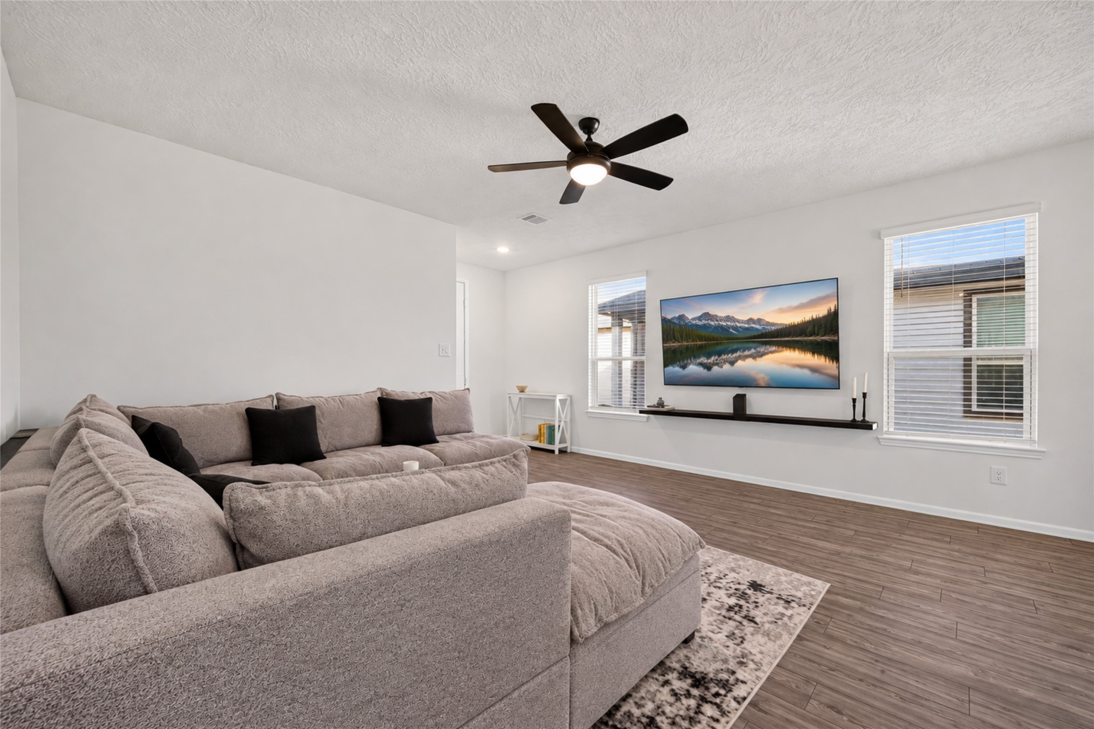 Enjoy movie nights, your favorite shows, or simply unwinding in this spacious living area. The neutral finishes and open design make it easy to personalize the space to reflect your style. Enjoy movie nights, your favorite shows, or simply unwinding in this spacious living area. The neutral finishes and open design make it easy to personalize the space to reflect your style.