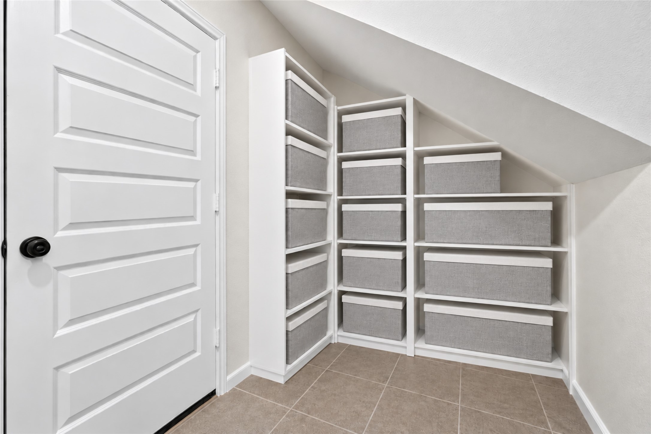 Enjoy the convenience of additional storage tucked neatly beneath the staircase. Built-in shelving provides an organized place for household essentials while keeping the main living areas clutter-free.