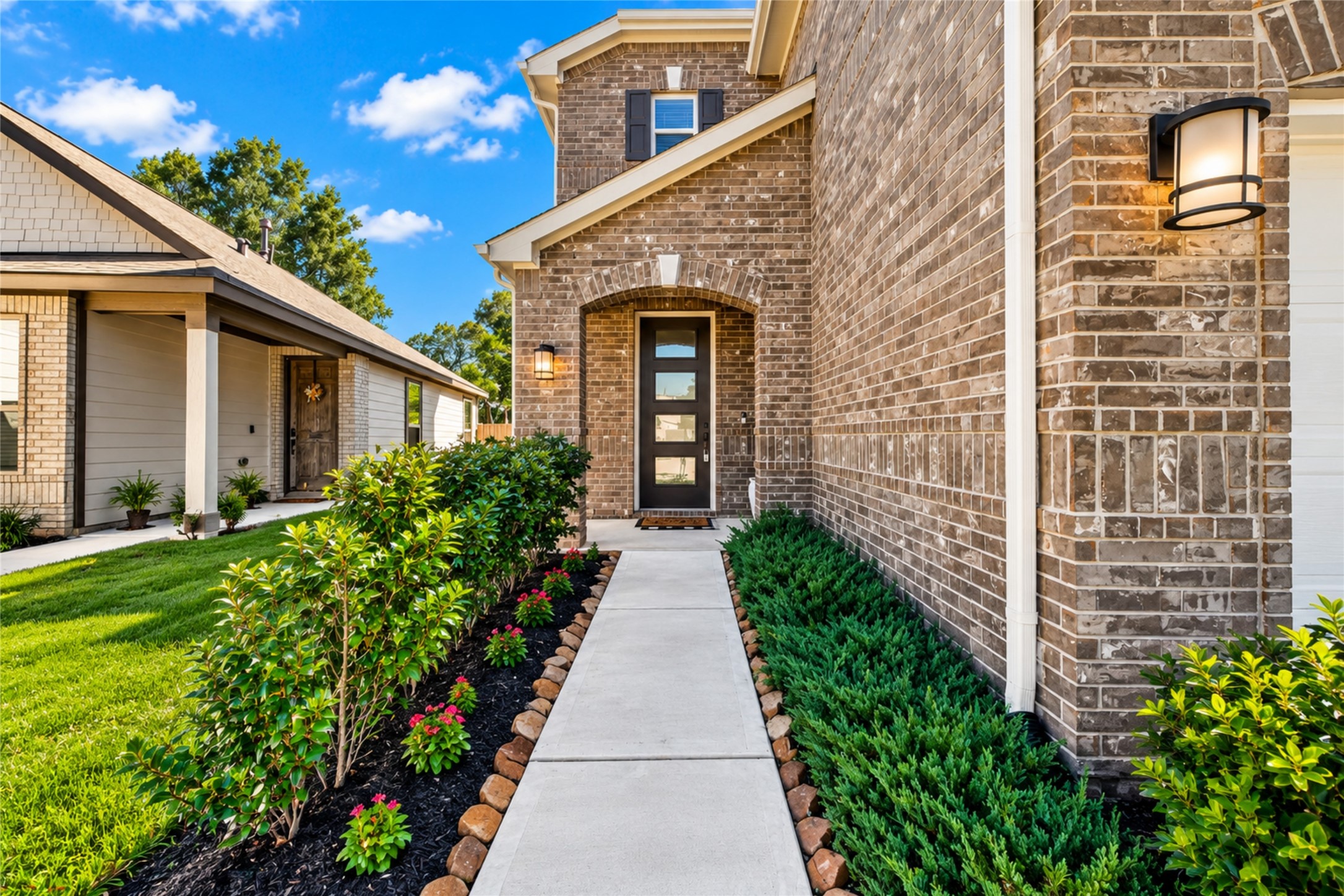 A beautifully landscaped walkway welcomes you to the covered front entrance of this charming home. Enjoy the welcoming curb appeal and the anticipation of discovering everything waiting inside. A beautifully landscaped walkway welcomes you to the covered front entrance of this charming home. Enjoy the welcoming curb appeal and the anticipation of discovering everything waiting inside.