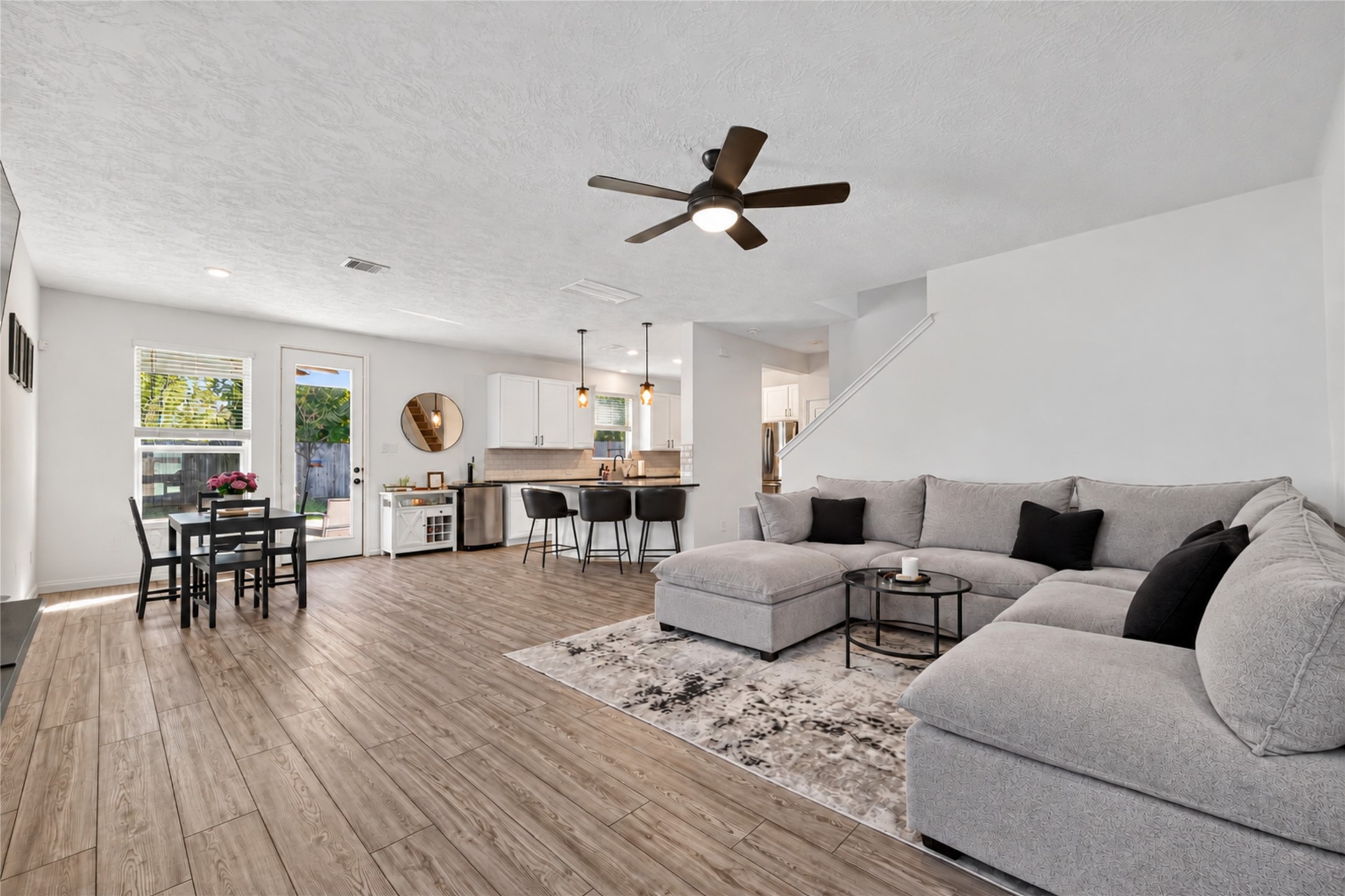 Experience the comfort of open-concept living with beautiful luxury vinyl plank flooring and abundant natural light. Whether enjoying a quiet evening or entertaining guests, this inviting living space offers room to relax and connect. Experience the comfort of open-concept living with beautiful luxury vinyl plank flooring and abundant natural light. Whether enjoying a quiet evening or entertaining guests, this inviting living space offers room to relax and connect.